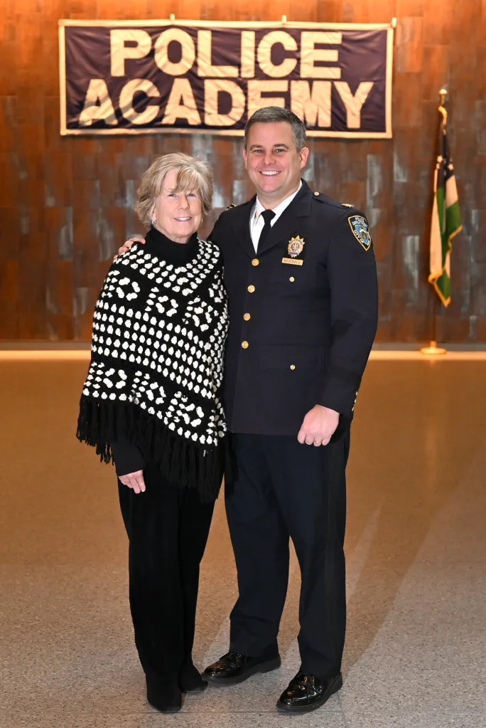 Patti Ann McDonald and NYPD Capt. Conor McDonald standing together in front of a 