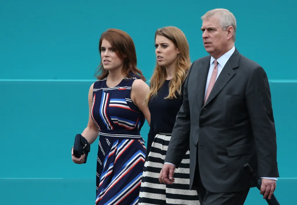 Britain's Princess Eugenie of York, Britain's Princess Beatrice of York and Britain's Prince Andrew, Duke of York leave Buckingham Palace to meet guests at the Patron's Lunch, a special street party outside Buckingham Palace in London on June 12, 2016, as part of the three day celebrations for Queen Elizabeth II's official 90th birthday. 