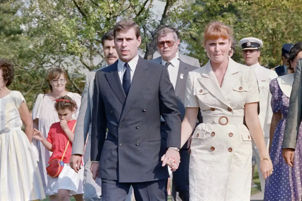 Prince Andrew and Lady Sarah Ferguson walk hand in hand.