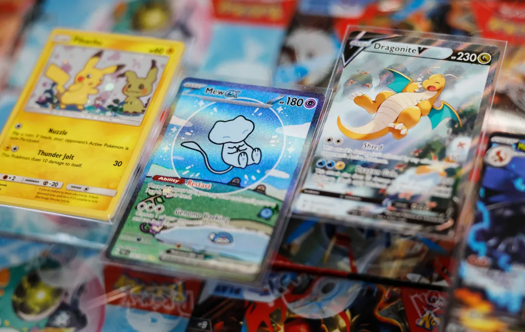 Photo illustration of collectible Pokémon cards including Pikachu, Mew, and Dragonite.