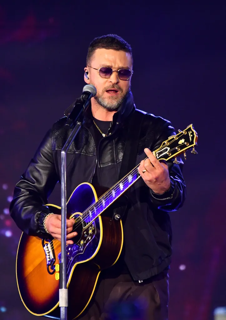 Justin Timberlake performing with an acoustic guitar.