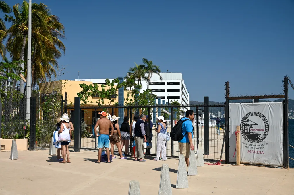 Tourists wait at the port of Acapulco, Mexico after boat services were canceled due to violence.