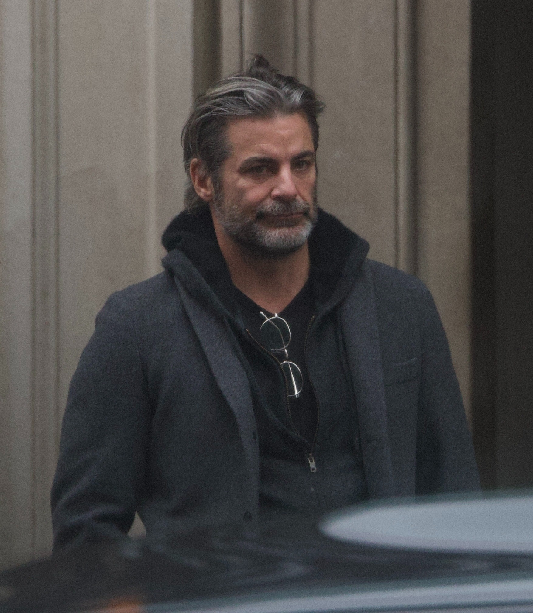 Curtis wore for a gray coat, black shirt and khakis.