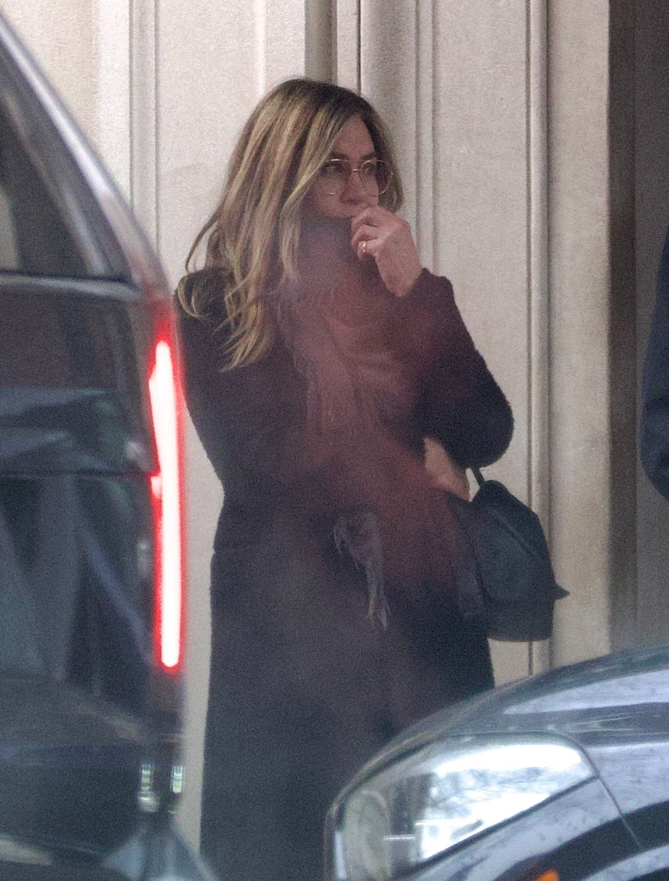 Aniston kept it casual in a jacket, jeans and a scarf.