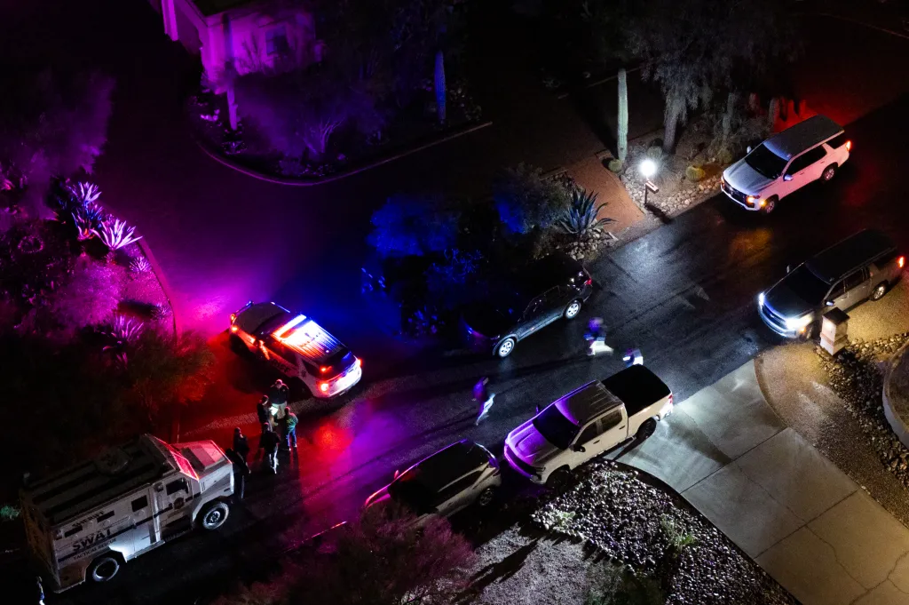 Aerial view of FBI and SWAT units operating in a neighborhood at night.