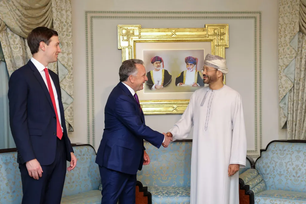 US special envoy Steve Witkoff shakes hands with Oman's Foreign Minister Badr bin Hamad al-Busaidi as Jared Kushner looks on during a meeting in Muscat.