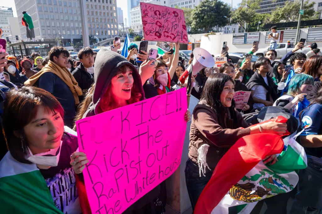 Students hold signs and flags during a protest outside the Federal Building in Los Angeles.
