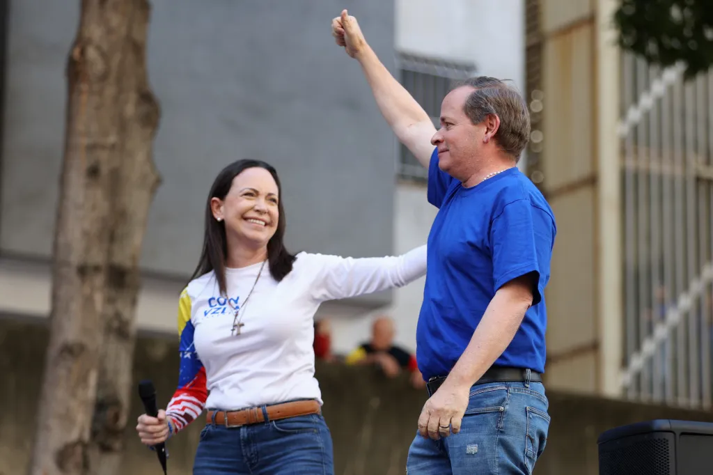 Former Deputy of the National Assembly of Venezuela, Juan Pablo Guanipa (R), gestures next to Venezuelan opposition leader Maria Corina Machado during a protest called by the opposition on the eve of the presidential inauguration in Caracas on January 9, 2025.