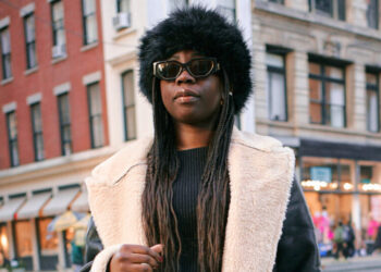 Cloaked in Sunglasses and a Big Coat