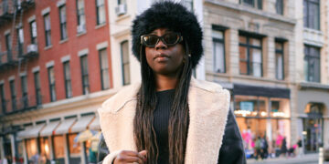 Cloaked in Sunglasses and a Big Coat