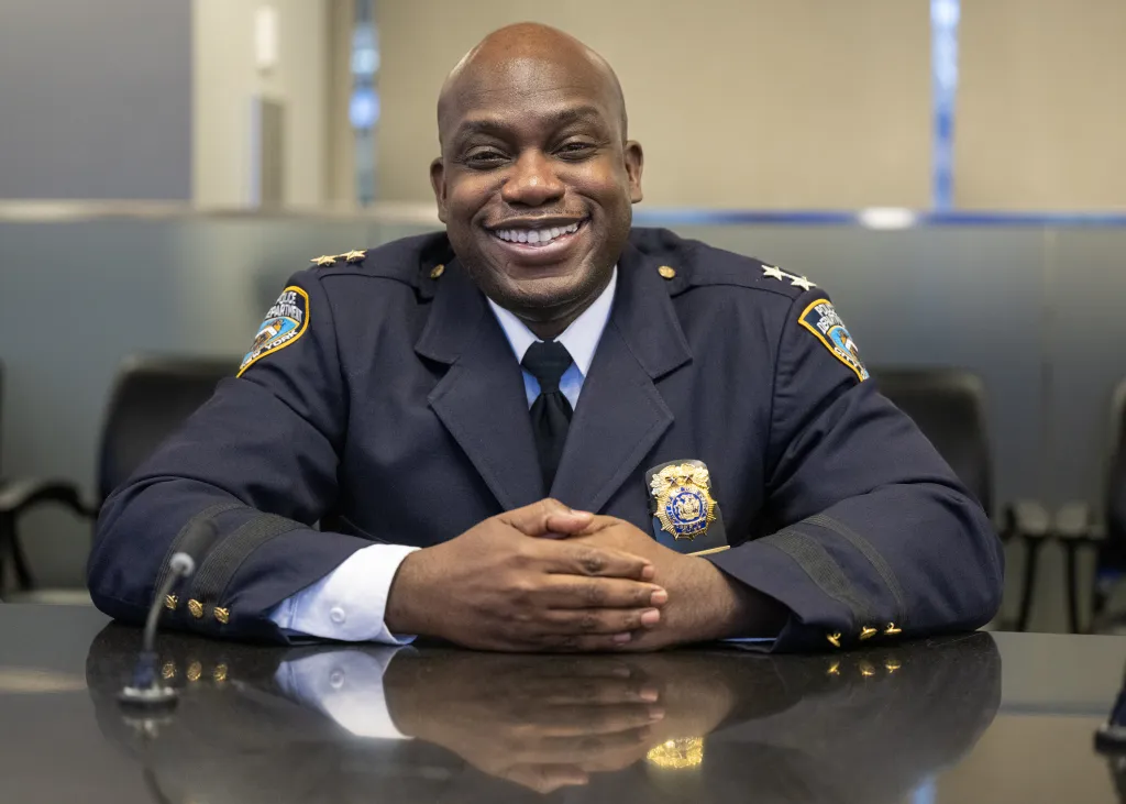 Christopher Mcintosh smiling during an NYPD promotion ceremony.