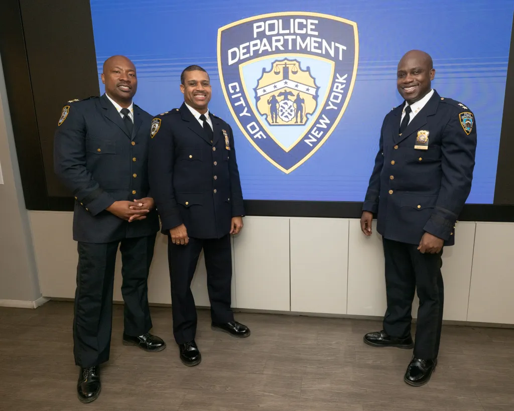 Three police officers, Aaron Edwards, Benjamin Gurley, and Christopher McIntosh, at an NYPD promotion ceremony.