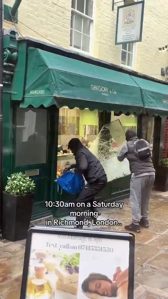 Two masked individuals robbing the Gregory & Co jewelry store in Richmond, London.