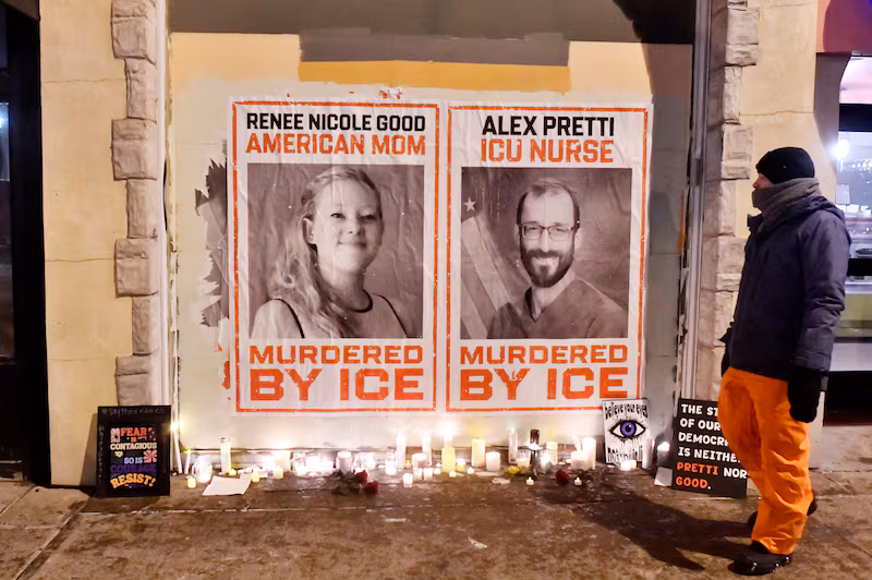 Posters of Renee Nicole Good and Alex Pretti, both US citizens fatally shot by immigration agents, are seen during a candlelight vigil in Minneapolis, Minnesota.