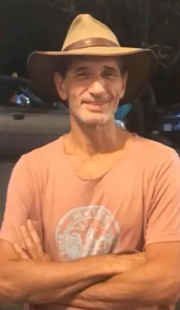 Portrait of Kurt Van Dyke smiling and wearing a hat.