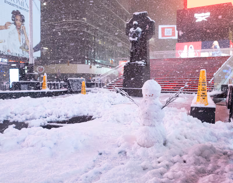 NEW YORK, NEW YORK - FEBRUARY 22: A snowman is seen in Times Square on February 22, 2026 in New York, New York. The northeast U.S. is bracing for an intense nor'easter with blizzard conditions, heavy snow, and strong winds. (Photo by Noam Galai/Getty Images)