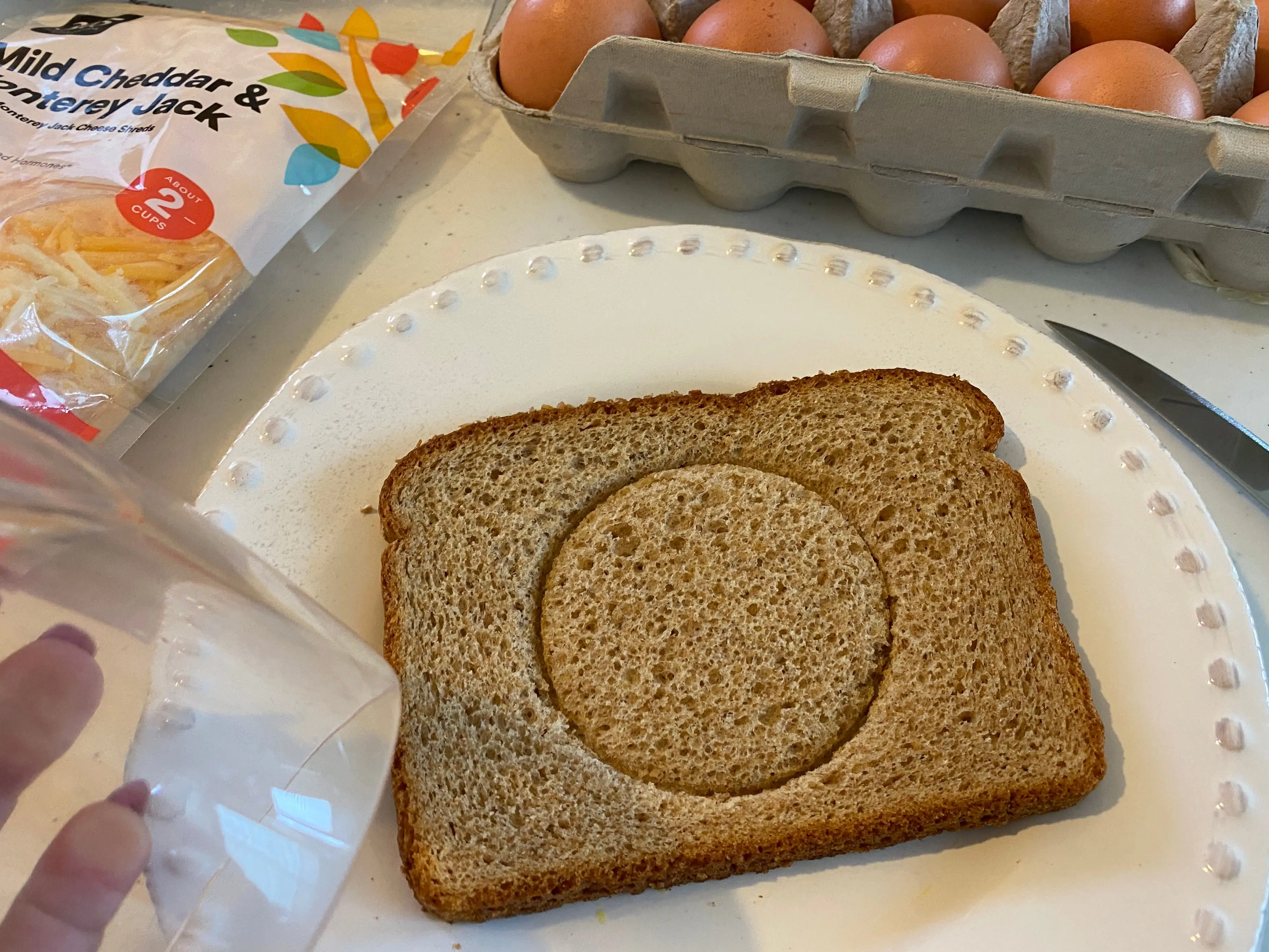bread with a hole cut out of it on white plate