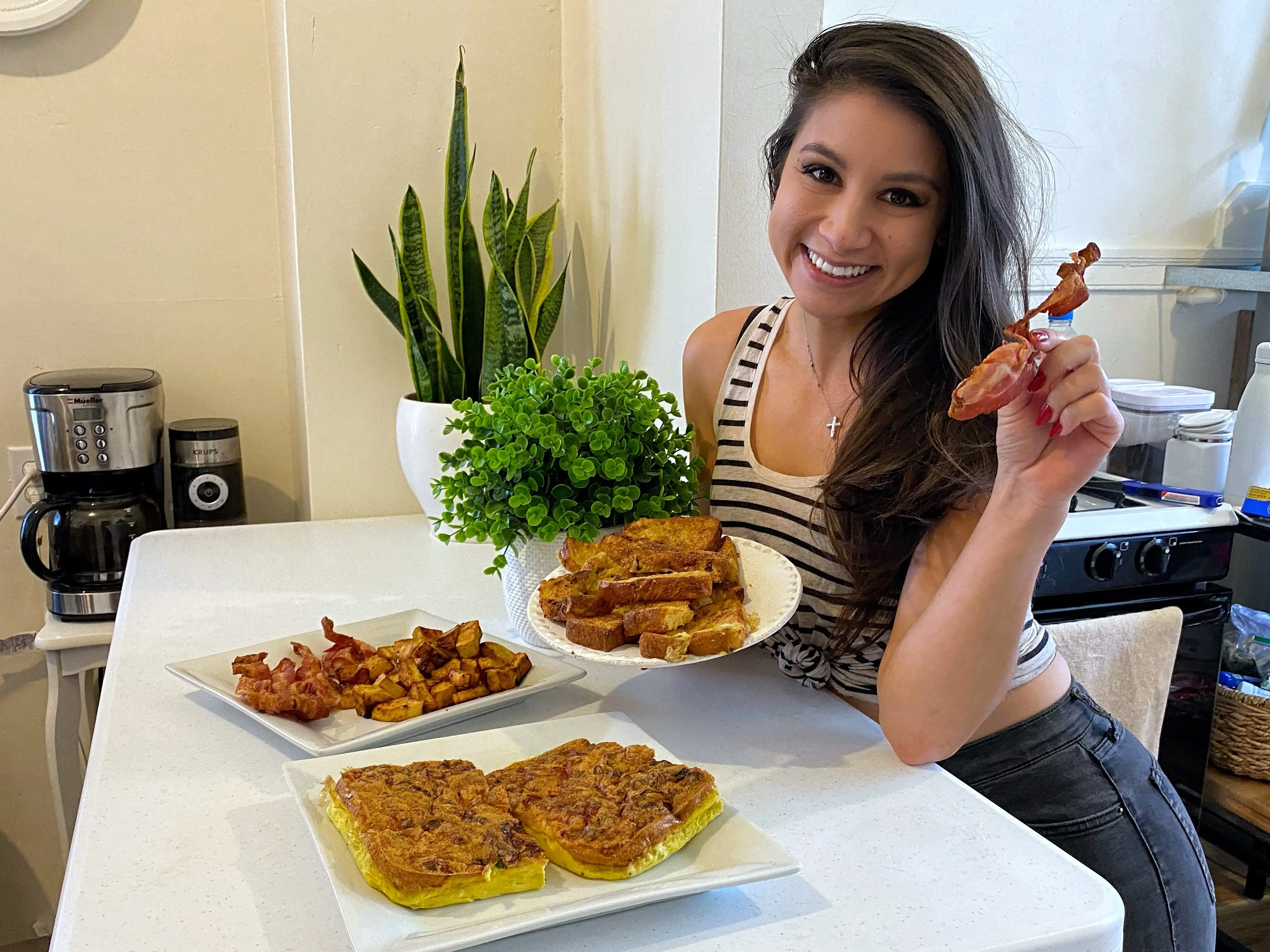 writer posing with plates of air fryer breakfasts