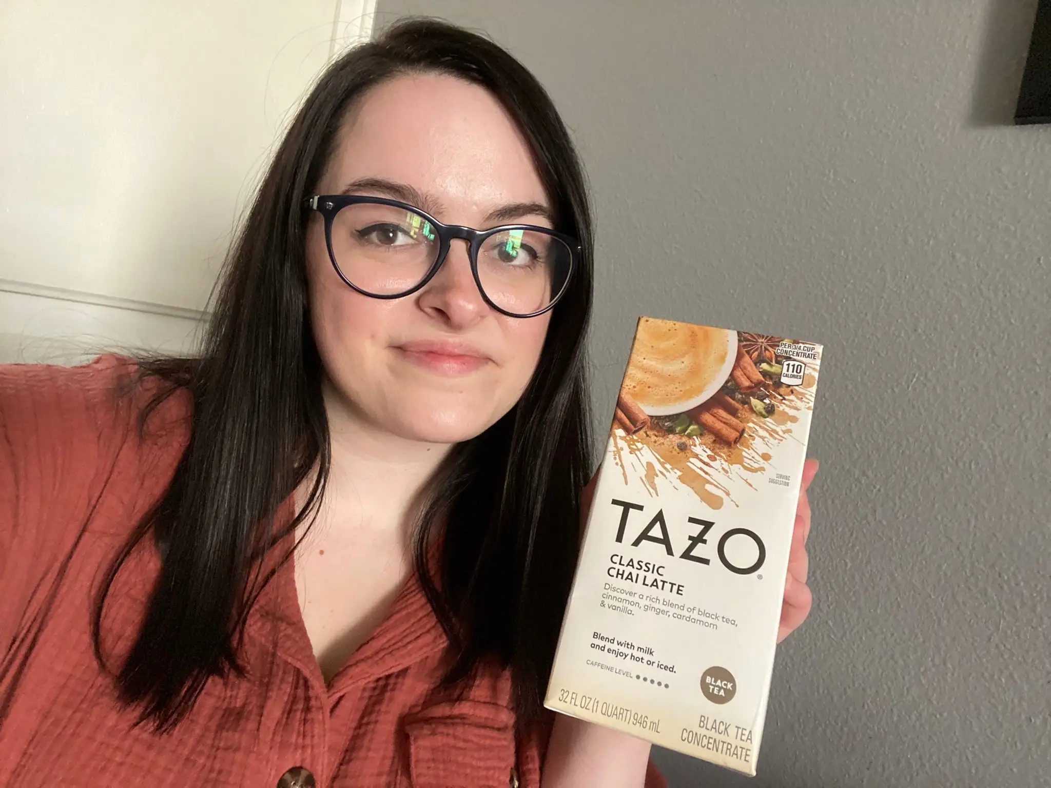 Author holding Tazo chai concentrate carton.