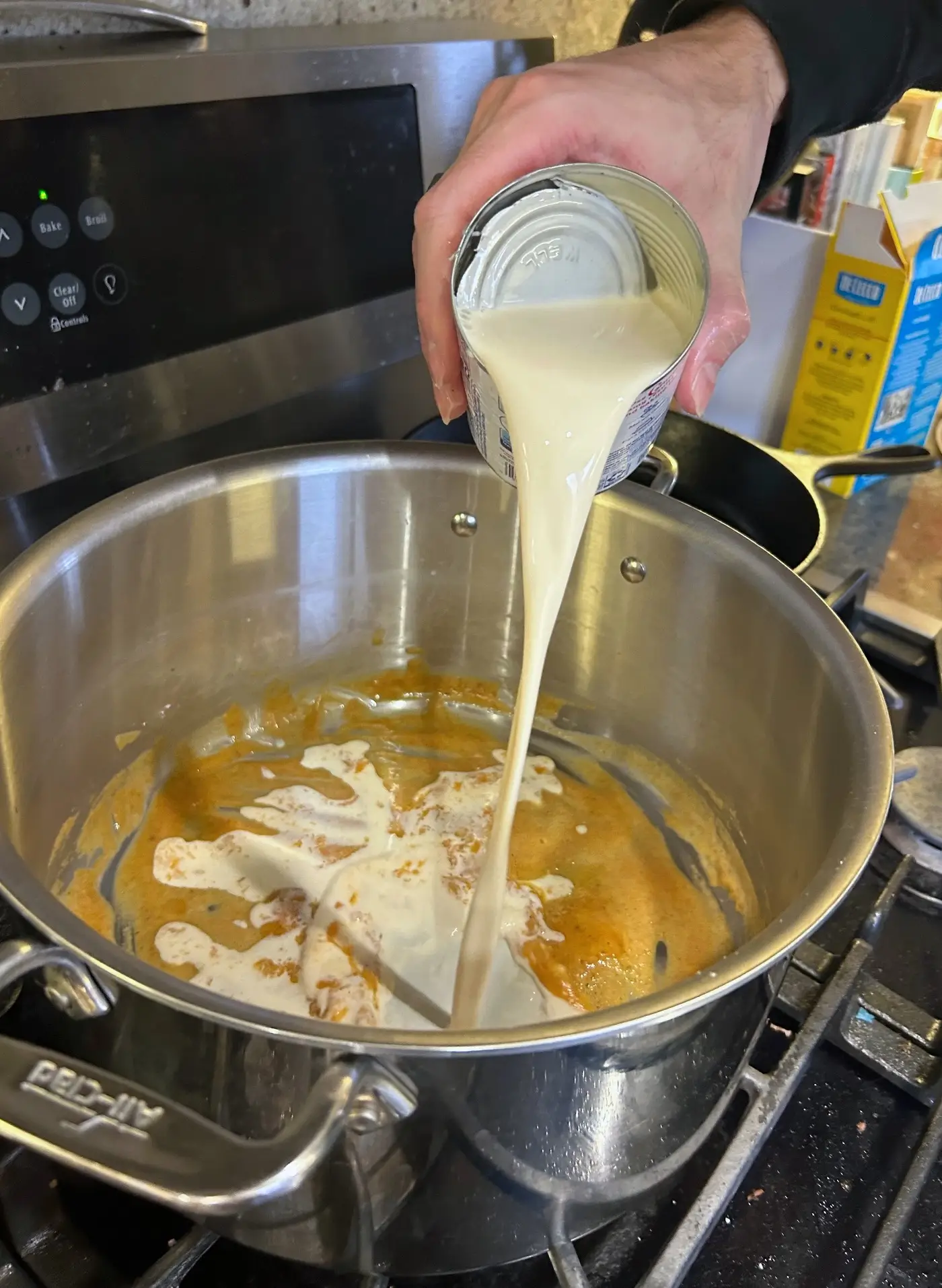 Adding condensed milk to roux for Tini's mac and cheese