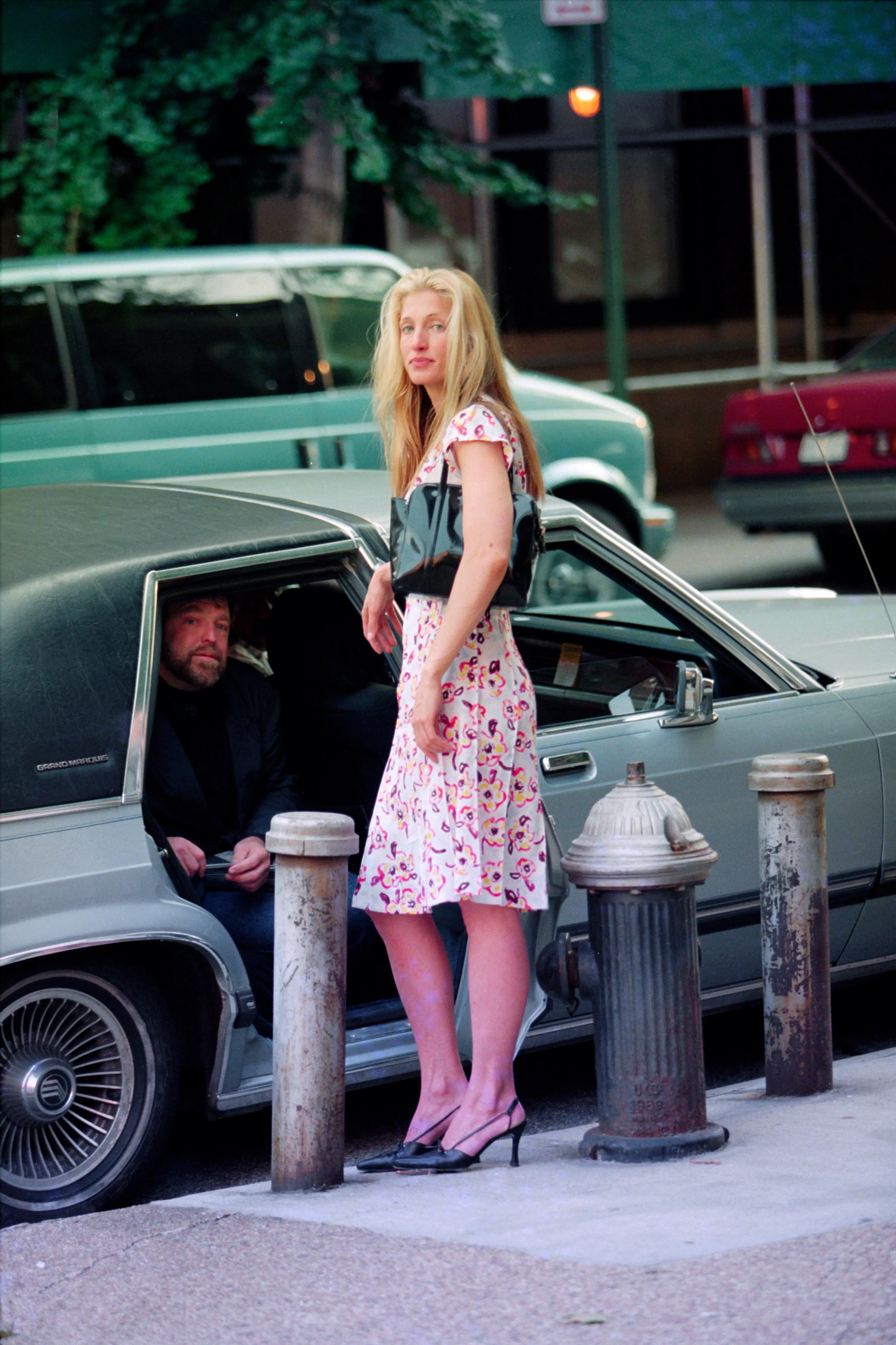 Carolyn Bessette-Kennedy wearing a pink floral dress in New York City in 1996