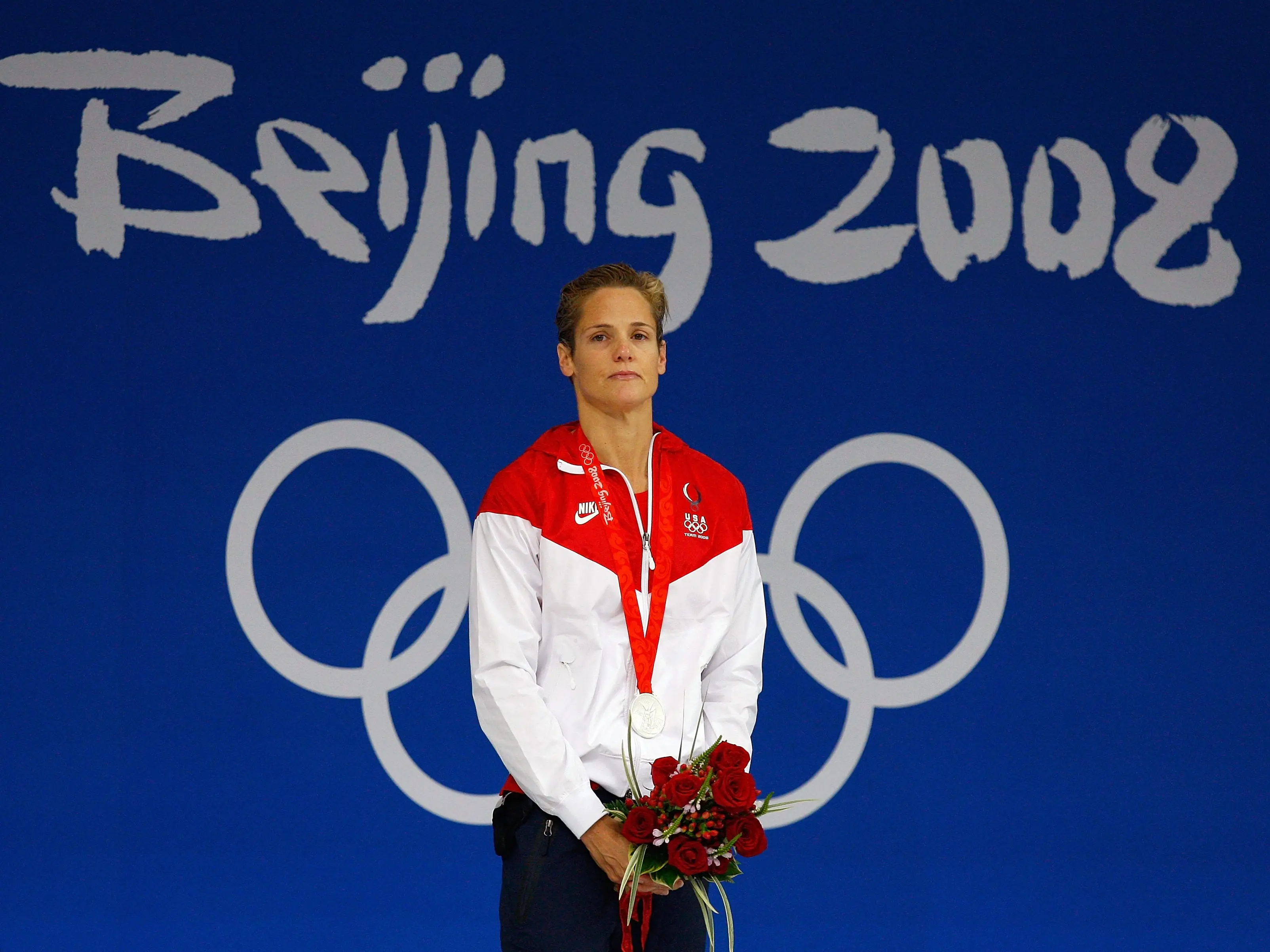 Dara Torres of the US stood on the podium wearing her silver medal and holding flowers after winning the women's 50-meter freestyle.