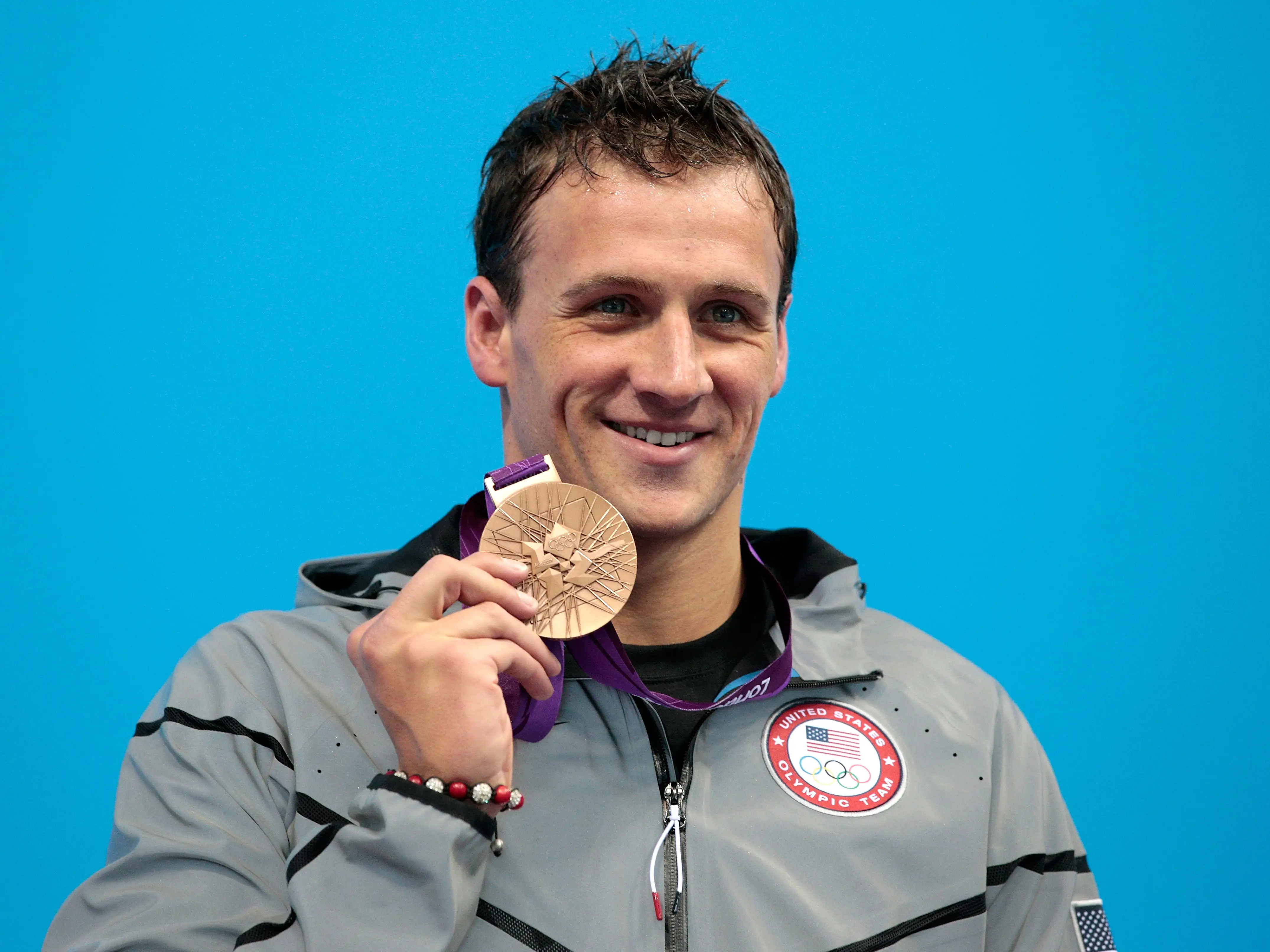 Ryan Lochte posed with his silver medal on the podium after winning the men's 200-meter individual medley.