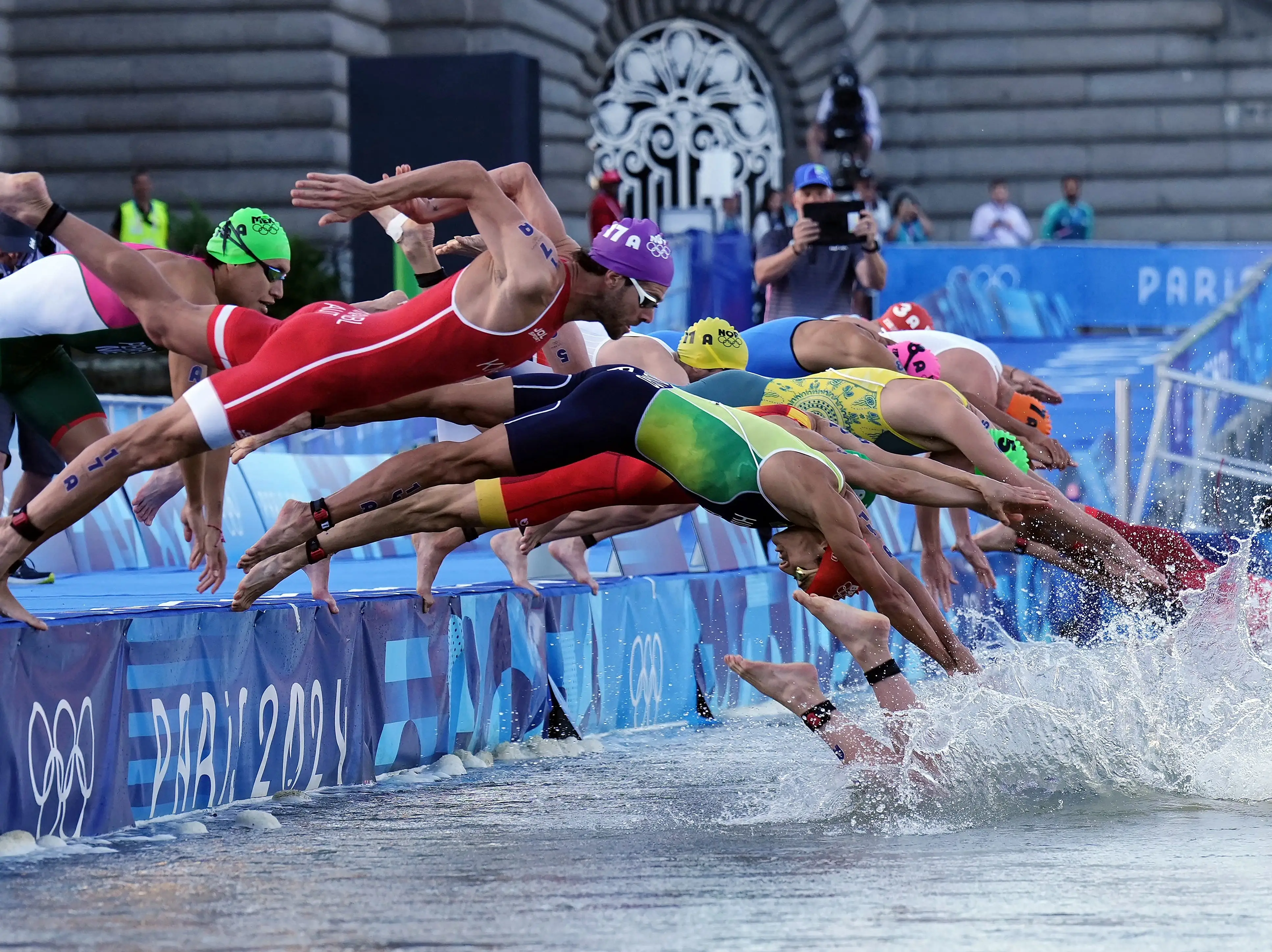 Athletes dove into the Seine during the mixed relay triathlon during the Paris Olympics.