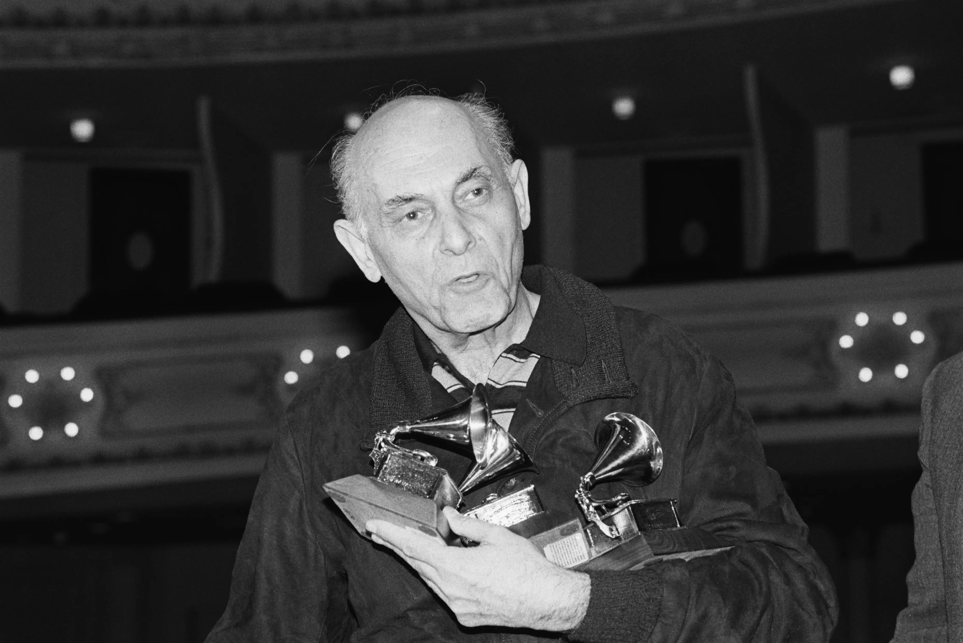 Georg Solti holding four Grammy Awards.