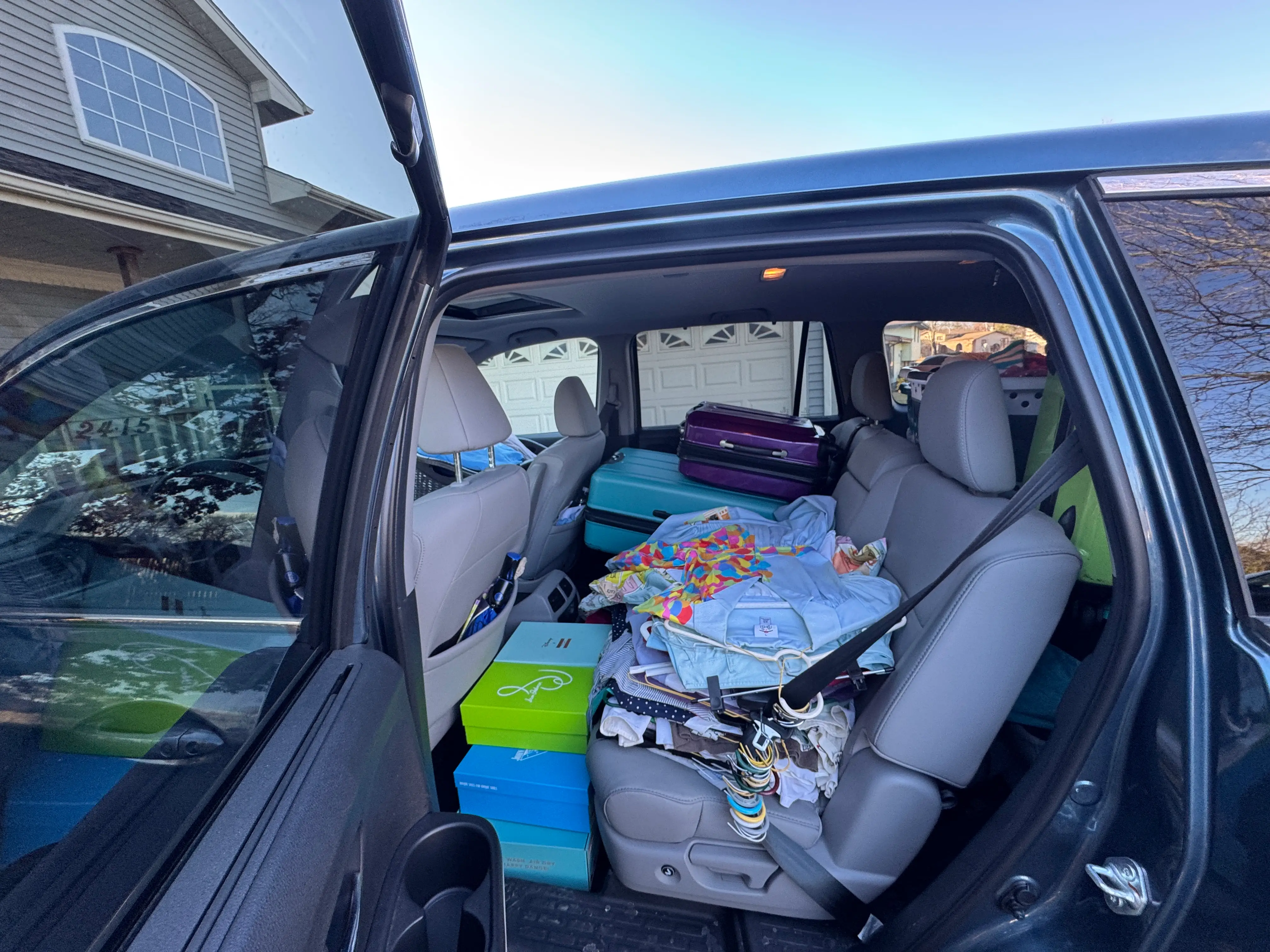 a car packed with clothes and suitcases