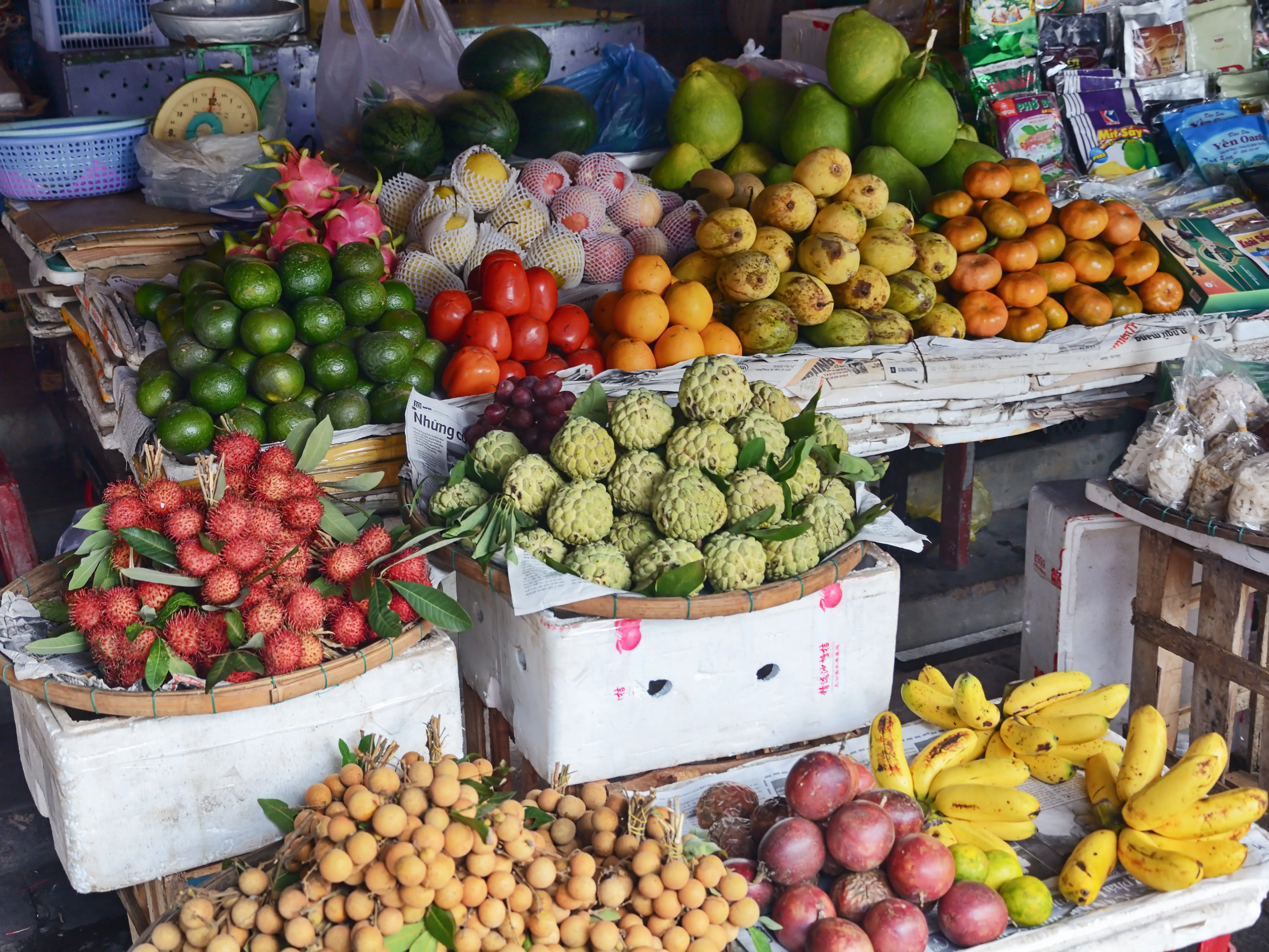 Various tropical fruits on display at a market.