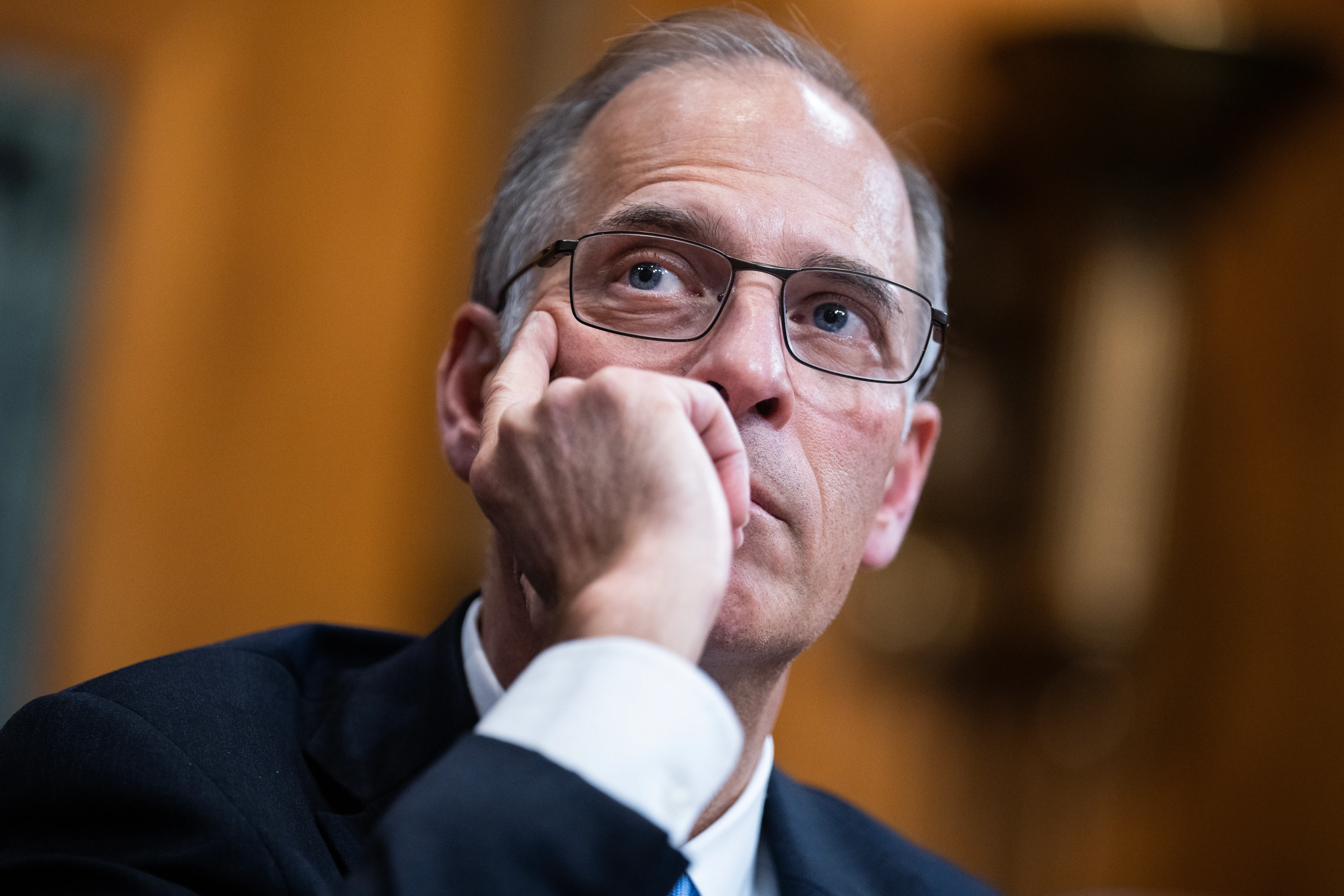 Mark Zandi, chief economist at Moody's Analytics, listens to someone speak while clasping his hand against his face.