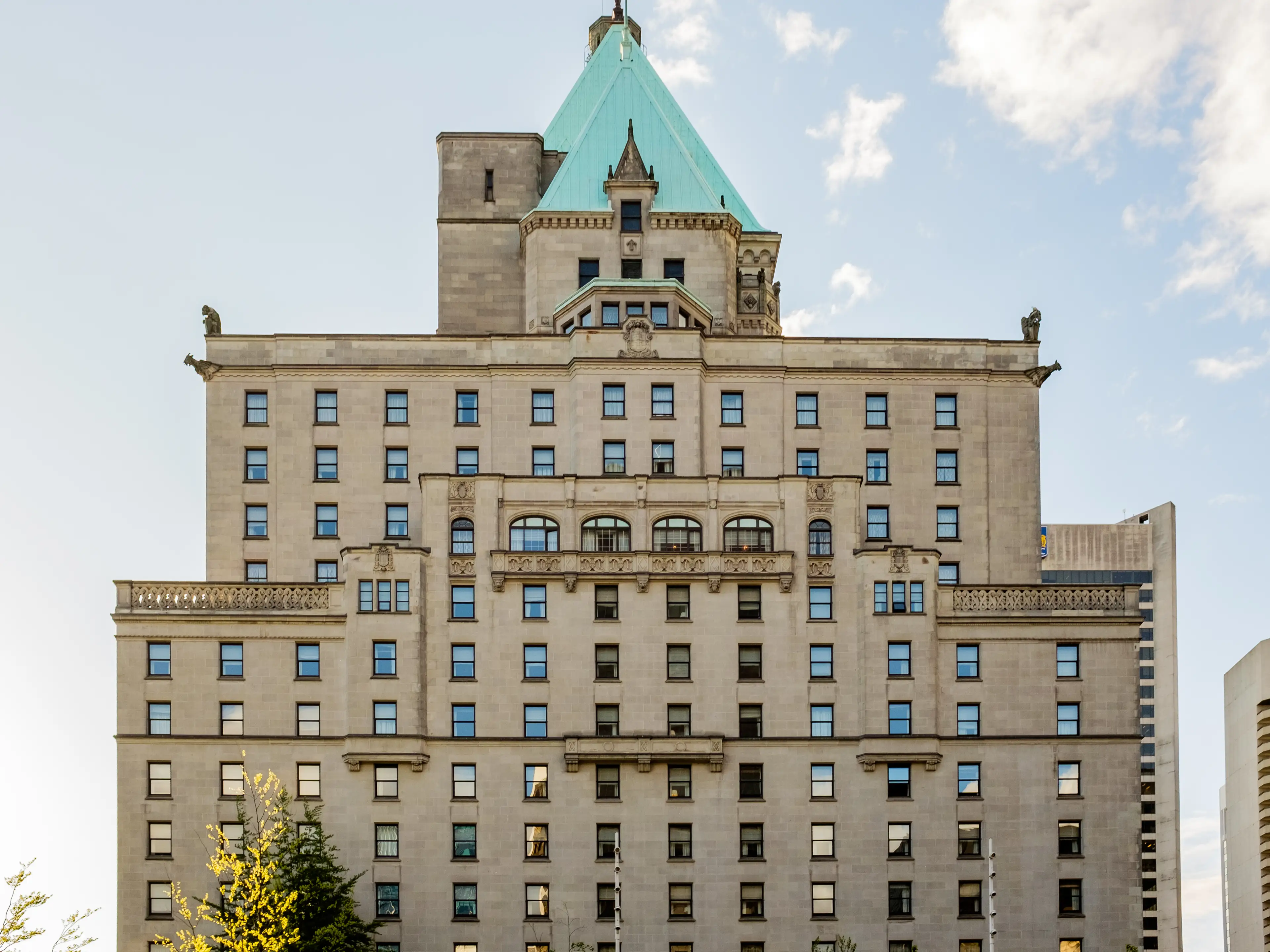 A tall castle hotel with clouds and blue skies in the background