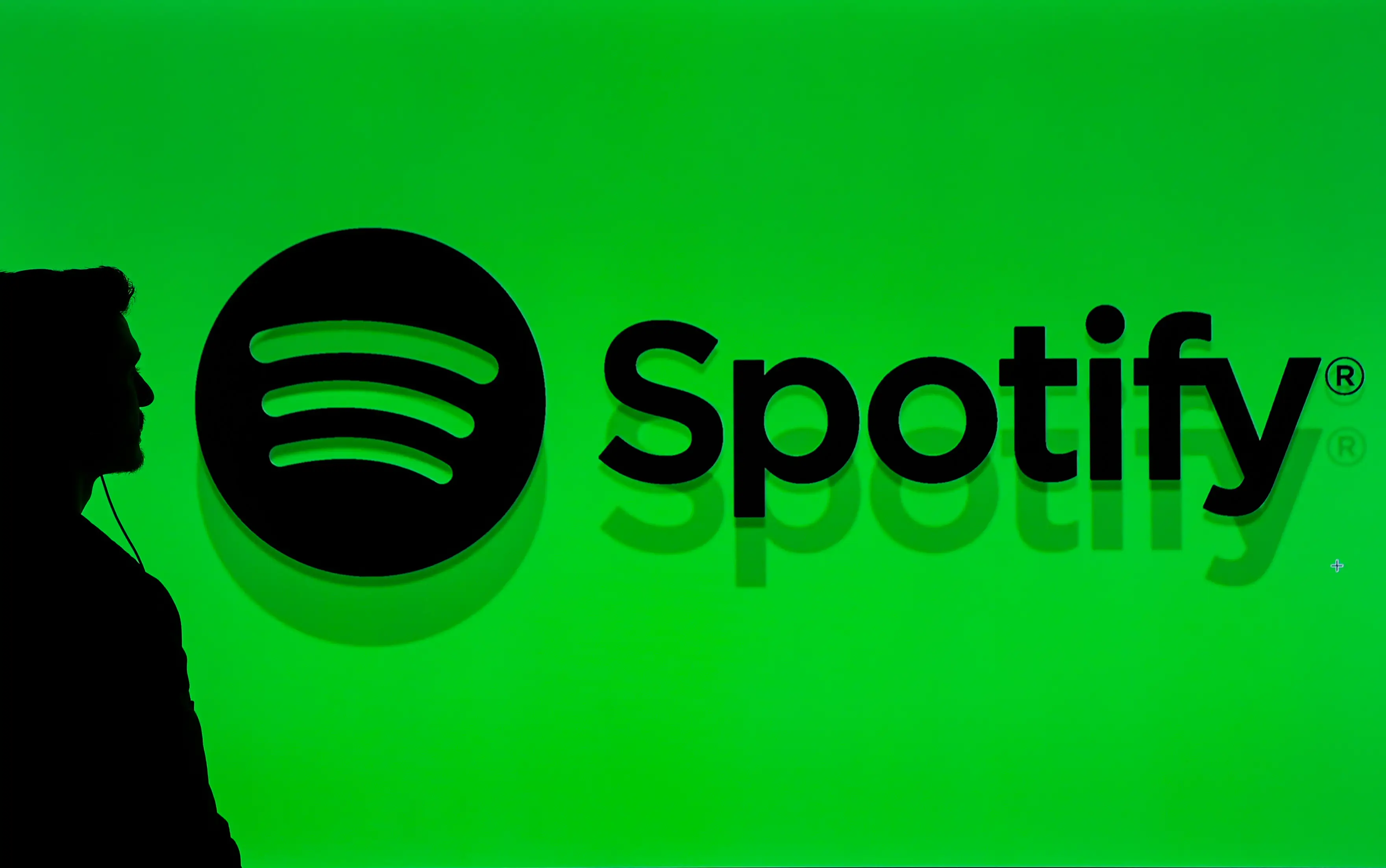 Spotify logo with a shadow of a man next to it