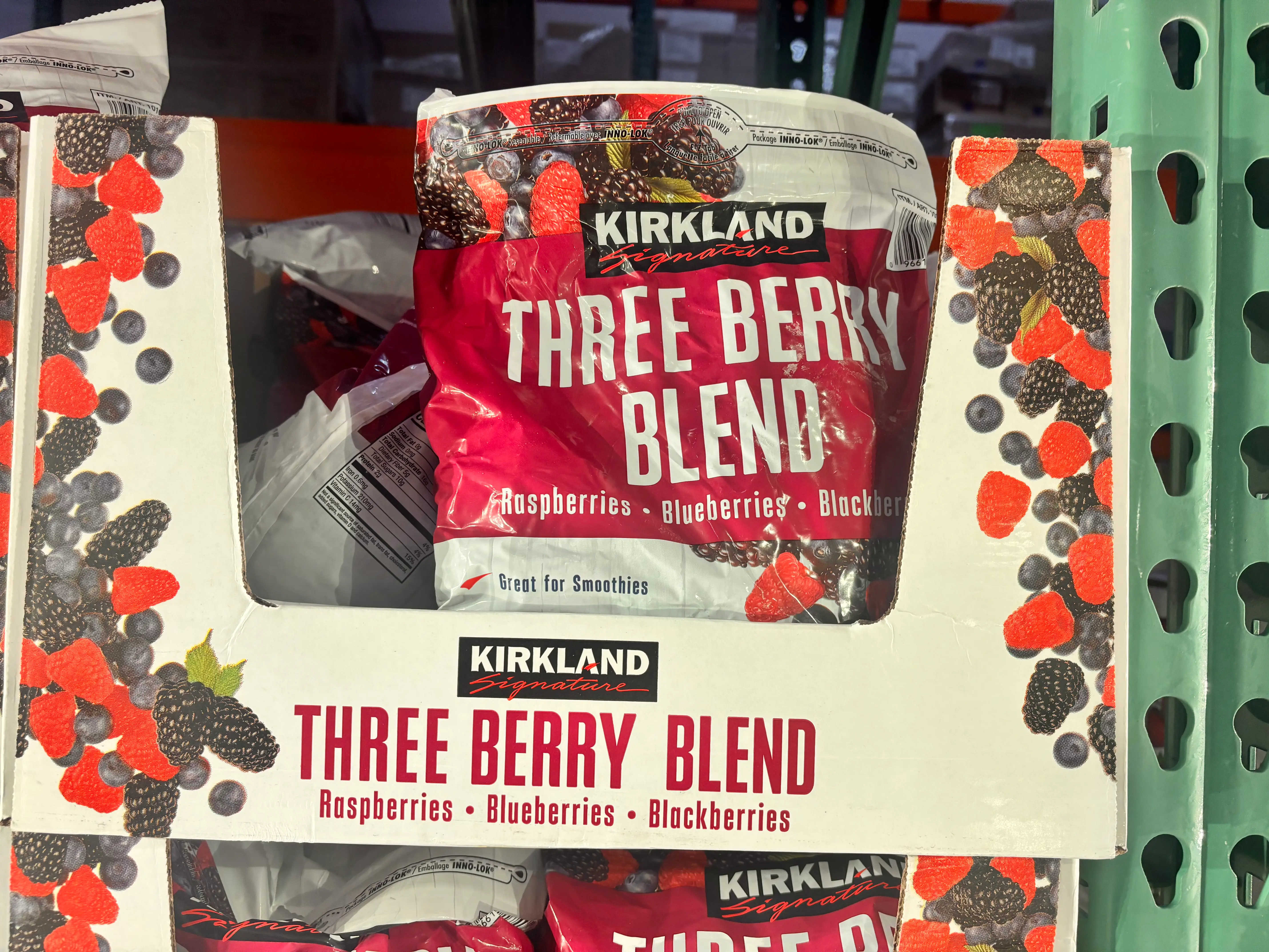 Kirkland Signature three-berry blend bag in box in Costco freezer