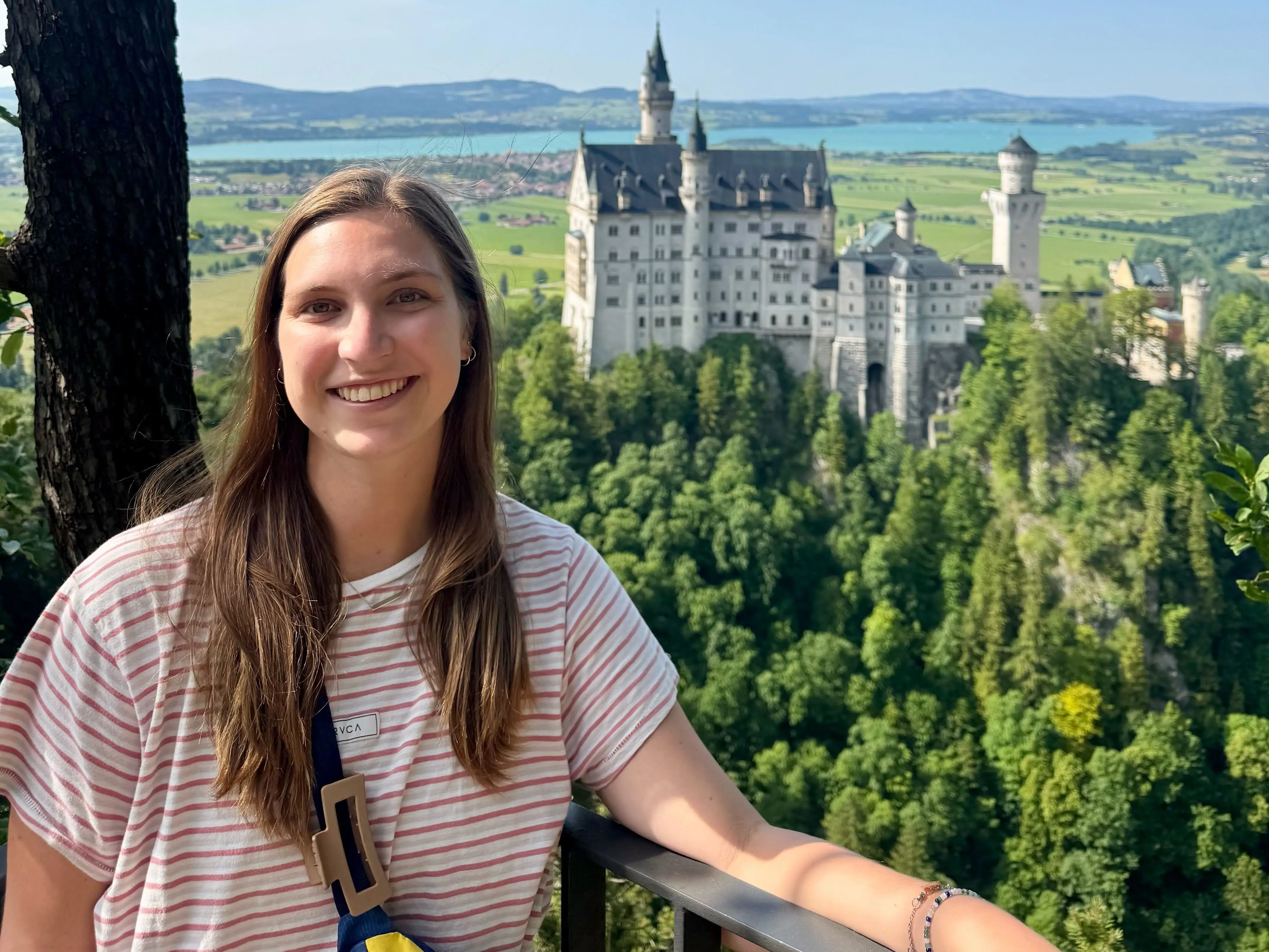 Hannah poses at a lookout point near a castle in Germany.