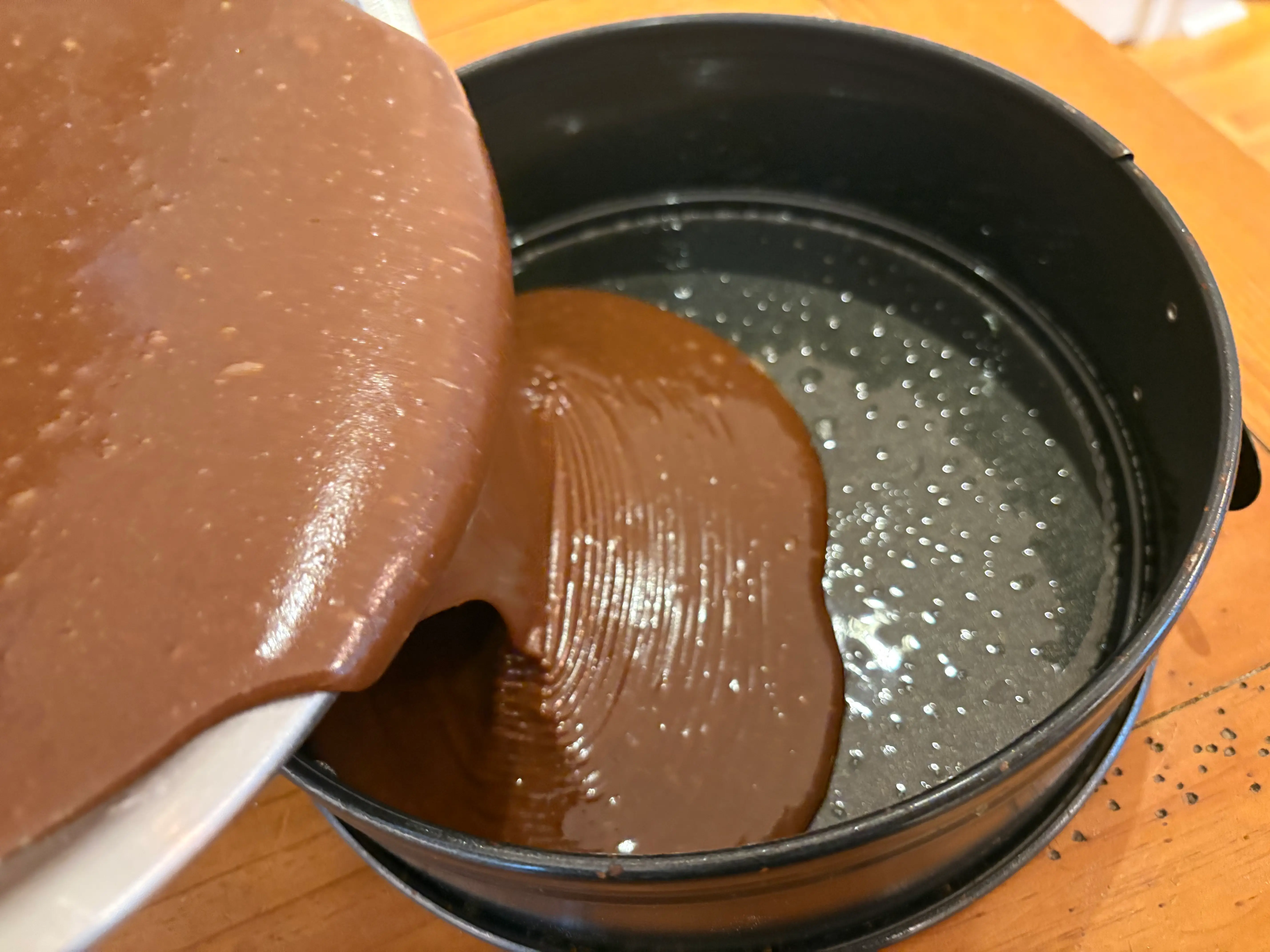 Pouring the batter into a cake pan.
