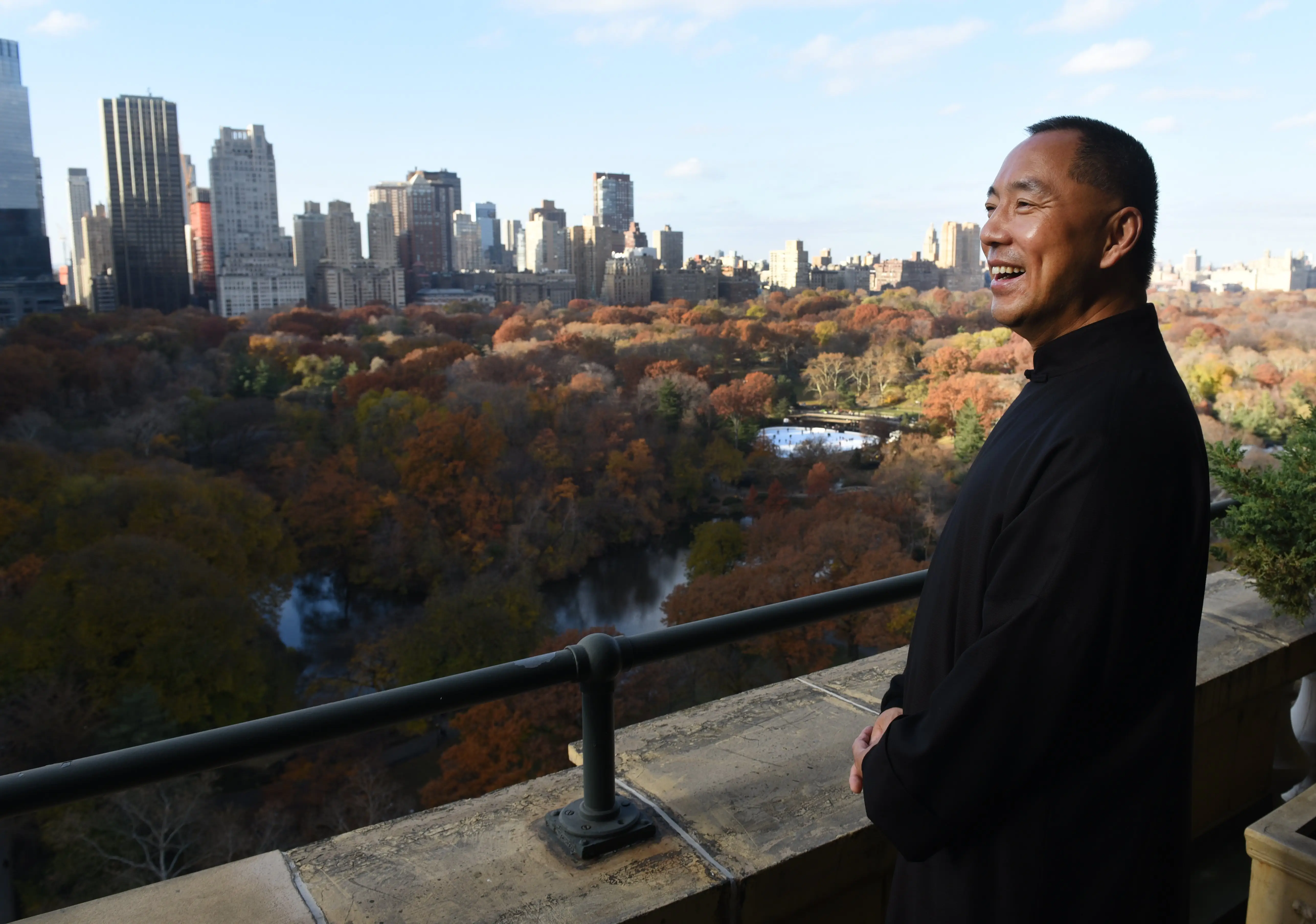 A man looks over Central Park from a skyrise