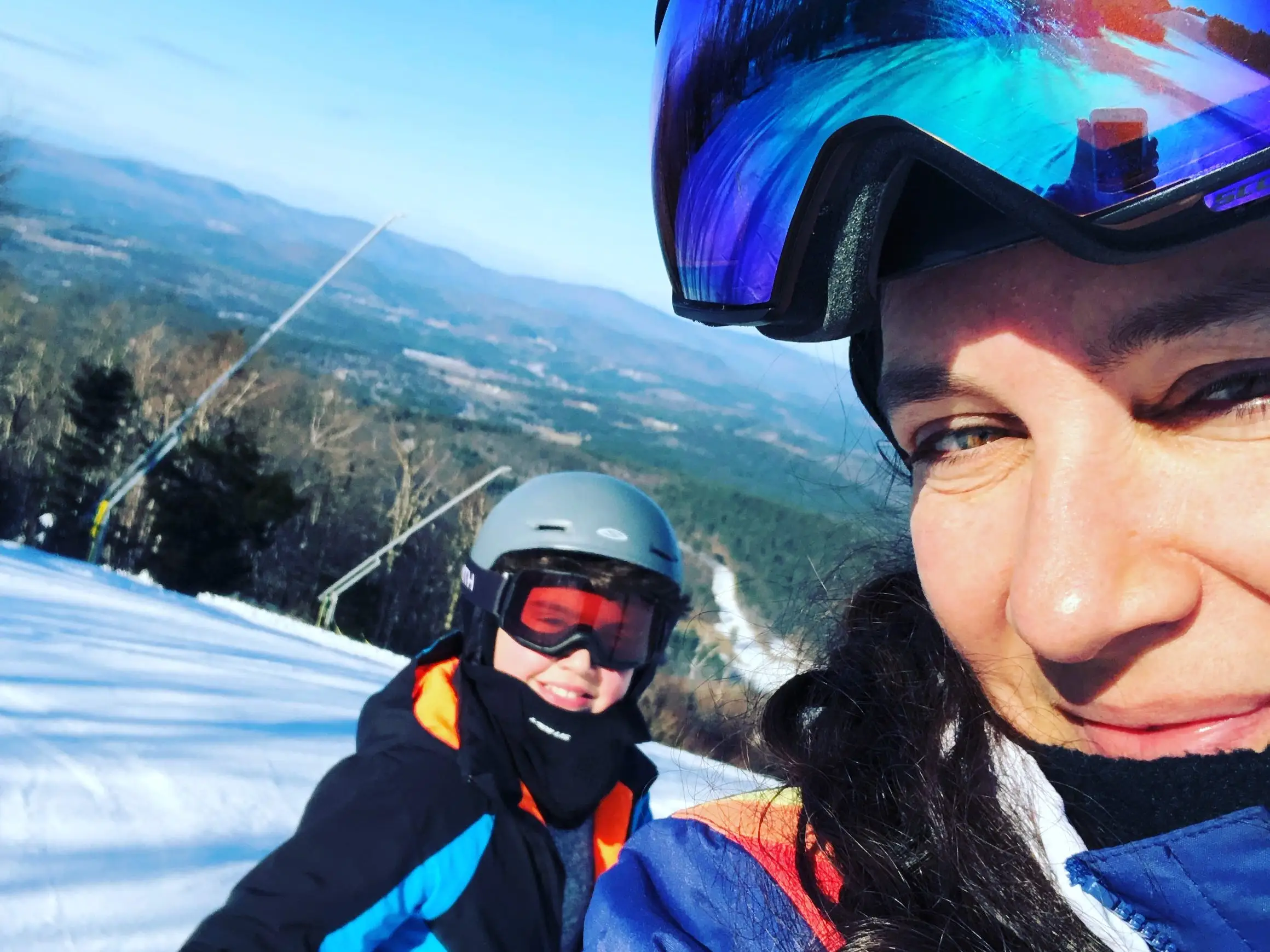 Mom and child skiing.