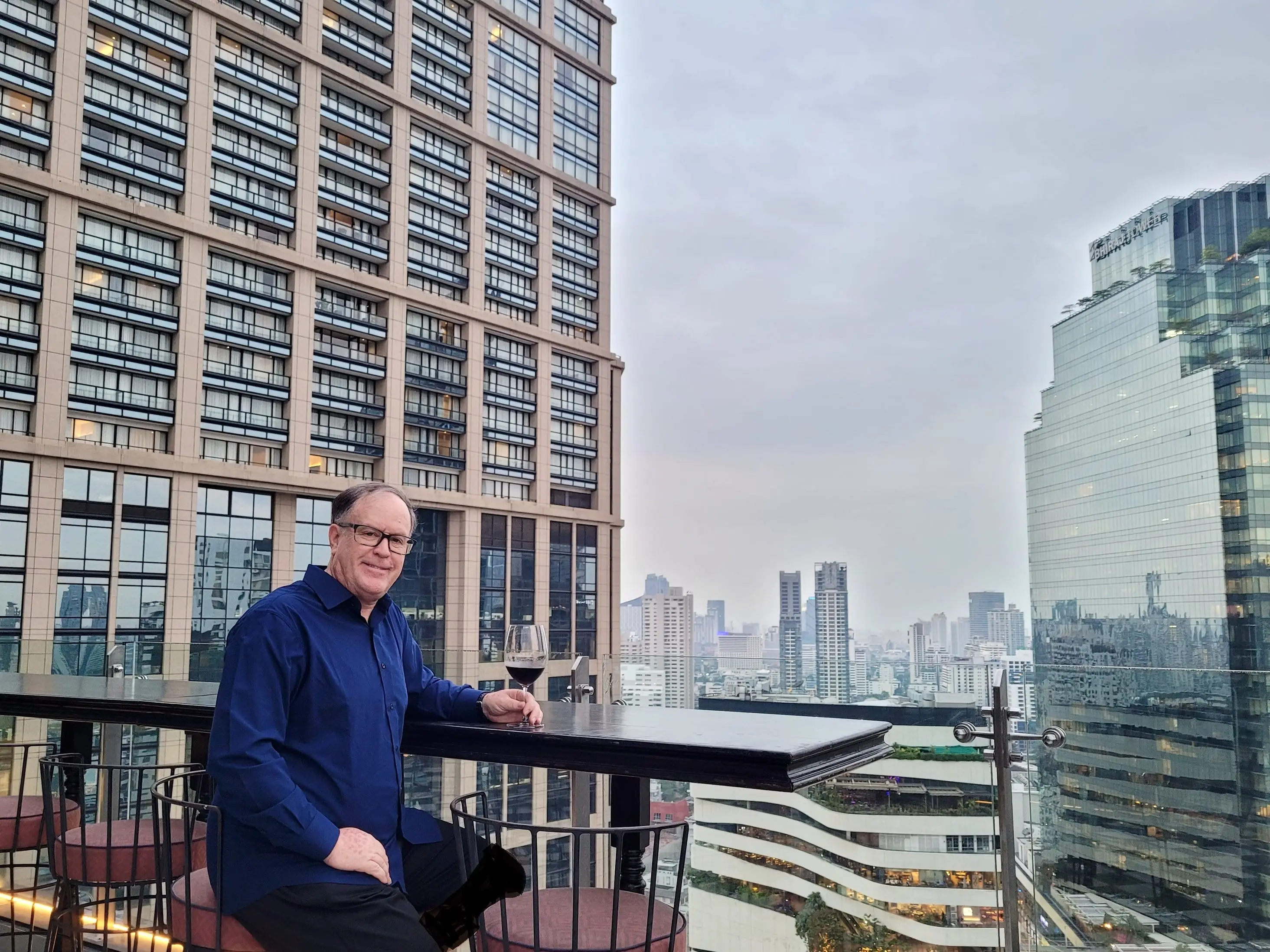 A man dressed in blue at a skybar in Bangkok, Thailand.