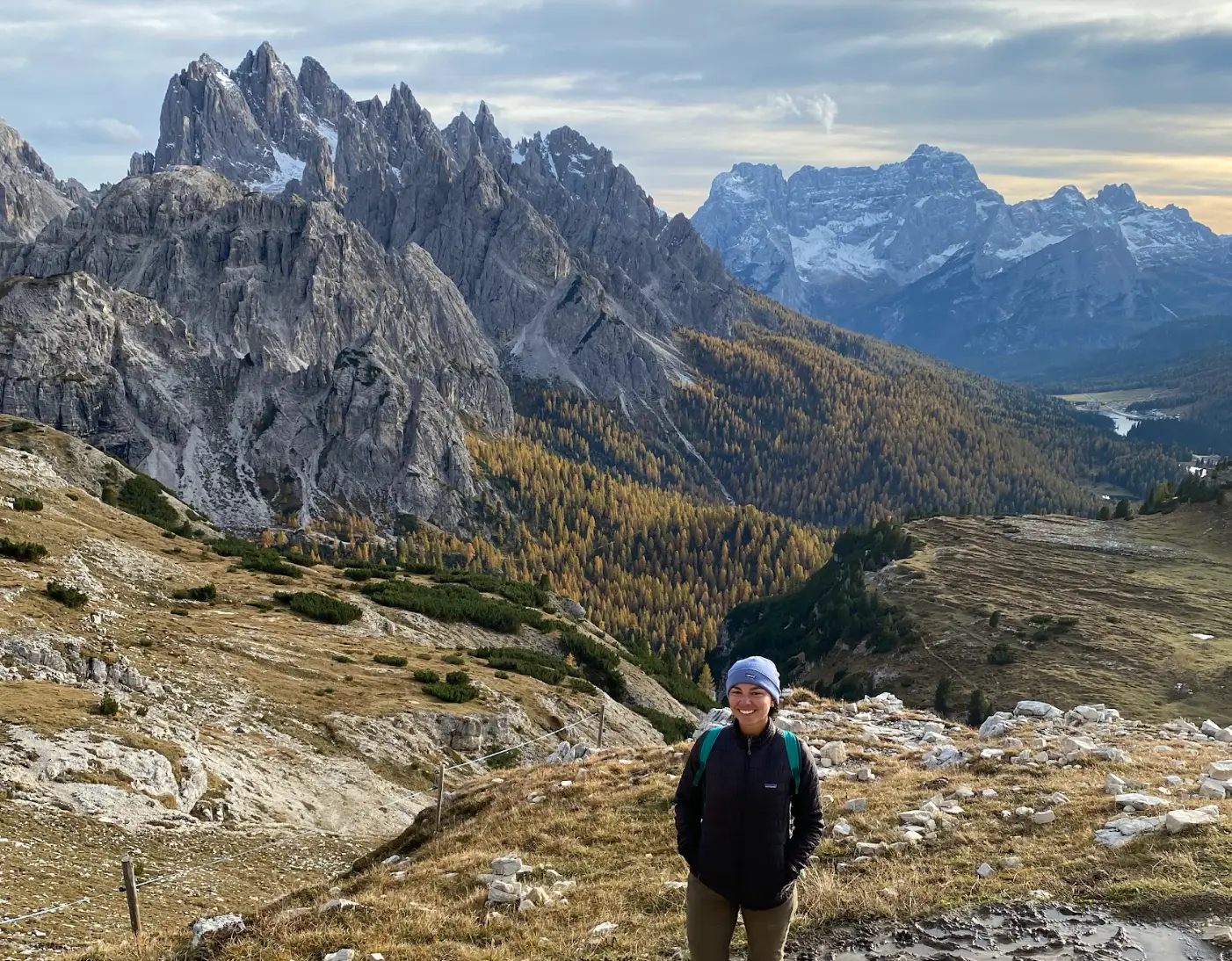 The writer standing in front of the Italian Dolomites.