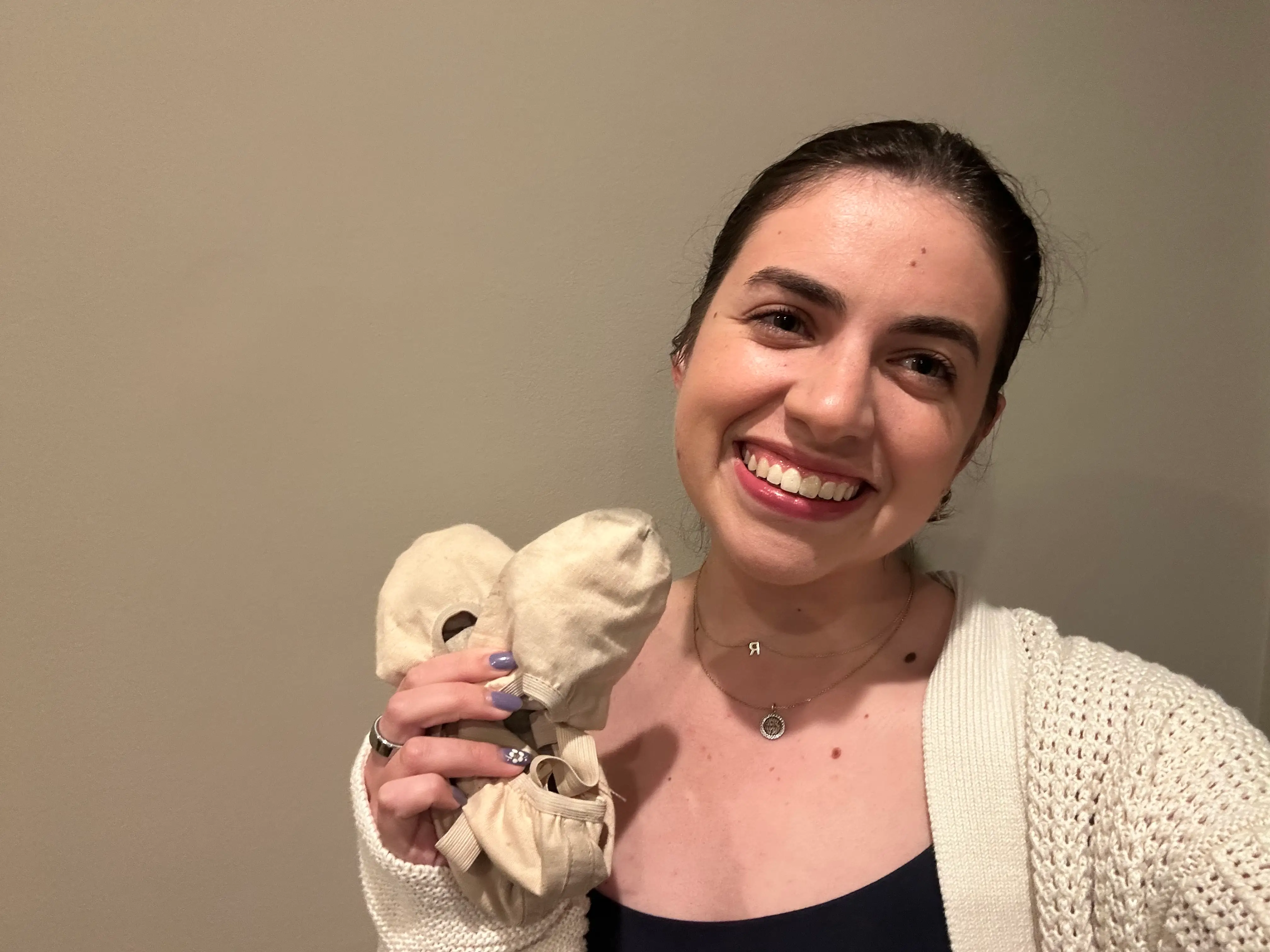 The author holding her ballet slippers in a selfie.