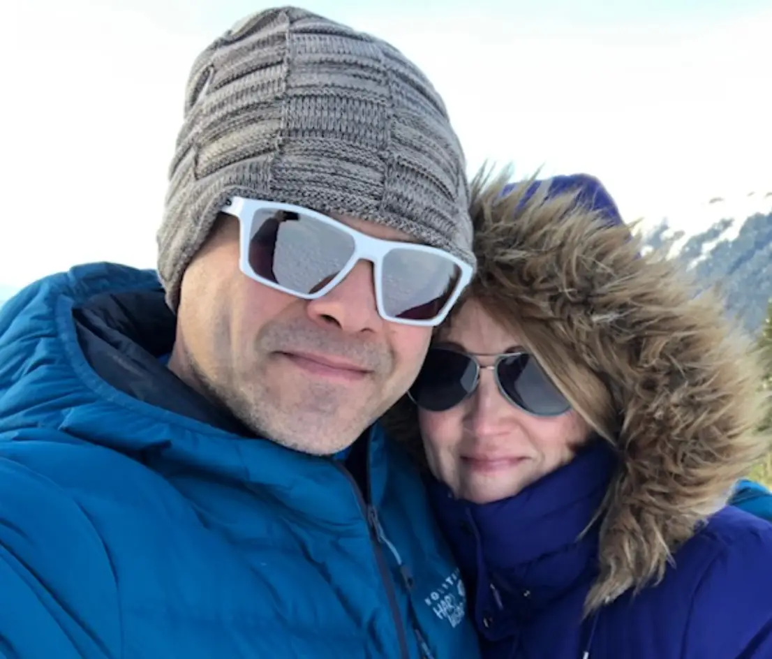 The writer and her husband bundled up in blue coats, outside in Alaska.