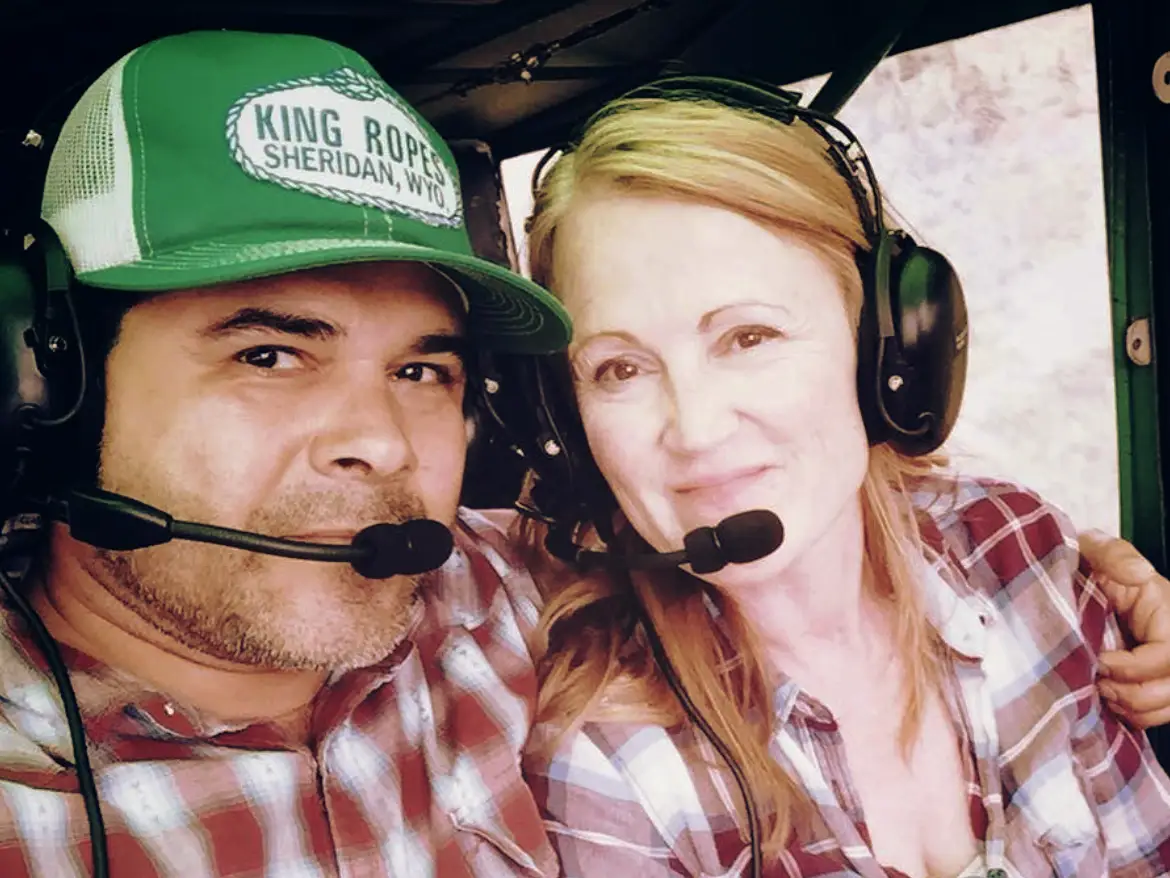 The writer and her partner in matching flannels and headsets on a plane.