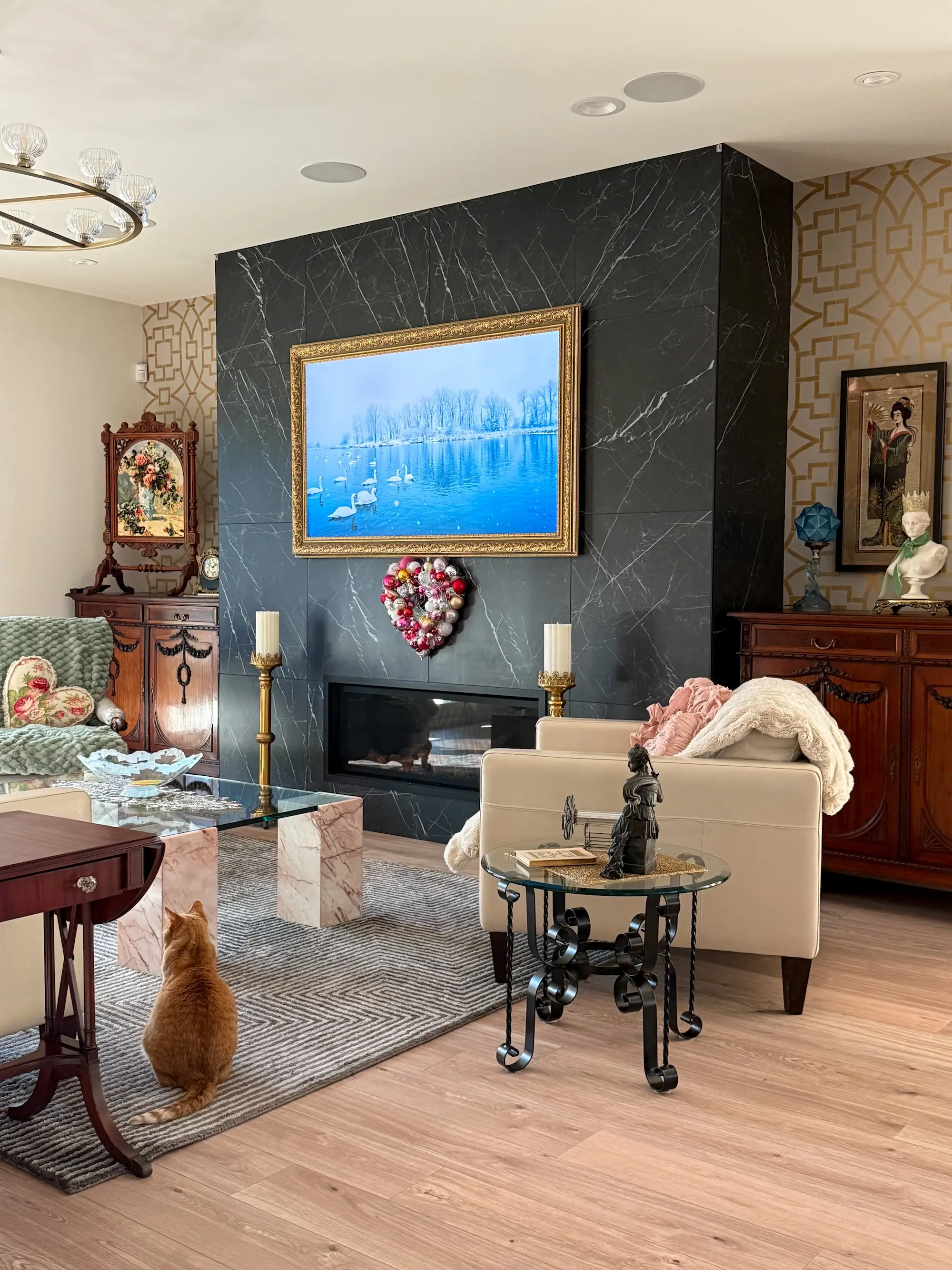A living area with a black stone fireplace and vintage furniture.