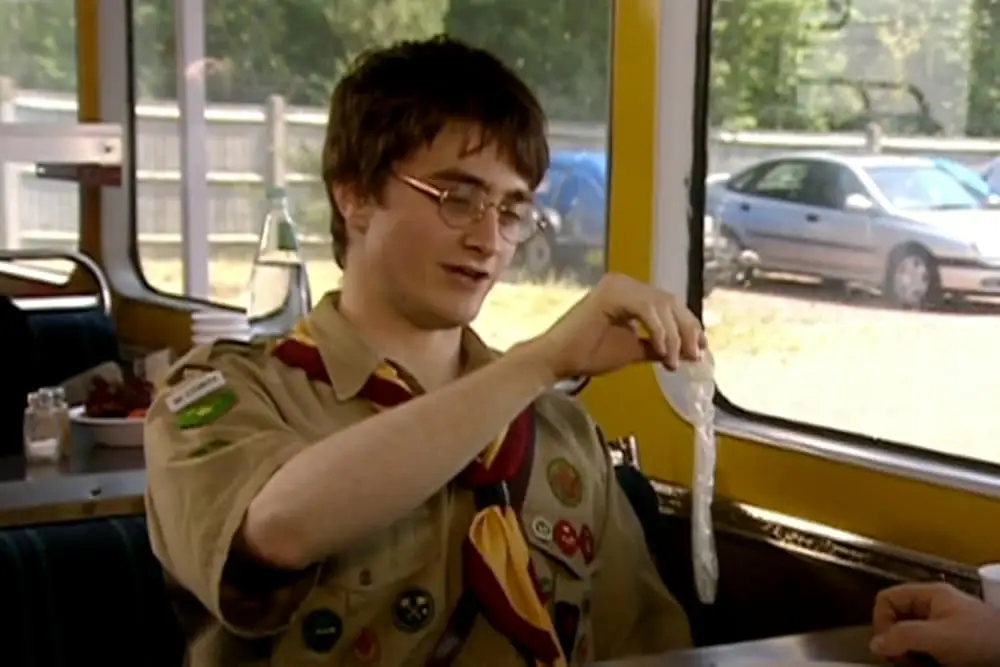 Daniel Radcliffe holding onto a condom in Extras episode
