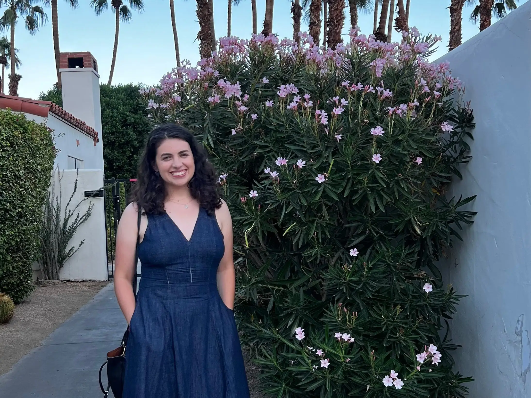 The author posing next to flowers.