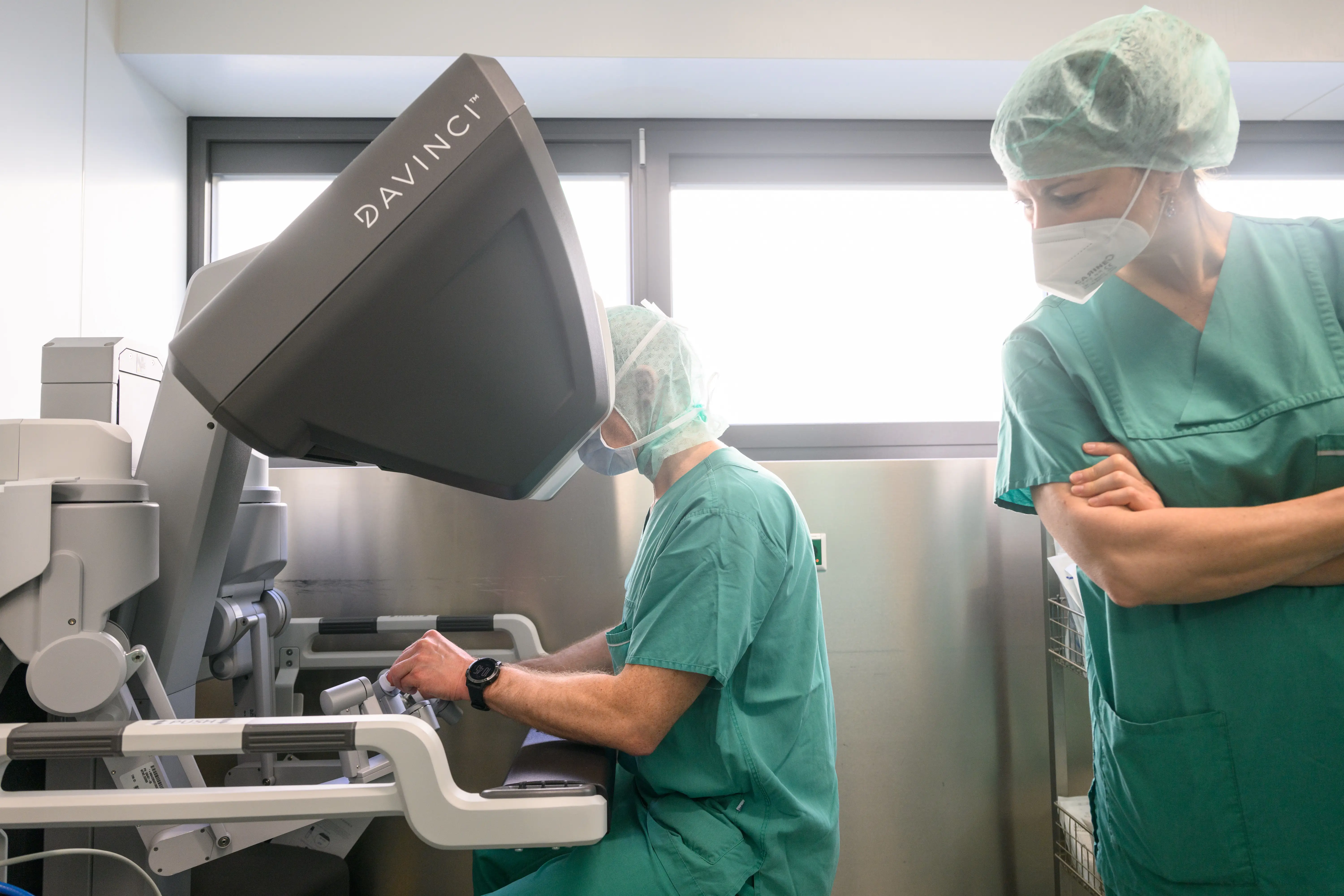 A surgeon looks into a Da Vinci robot console.