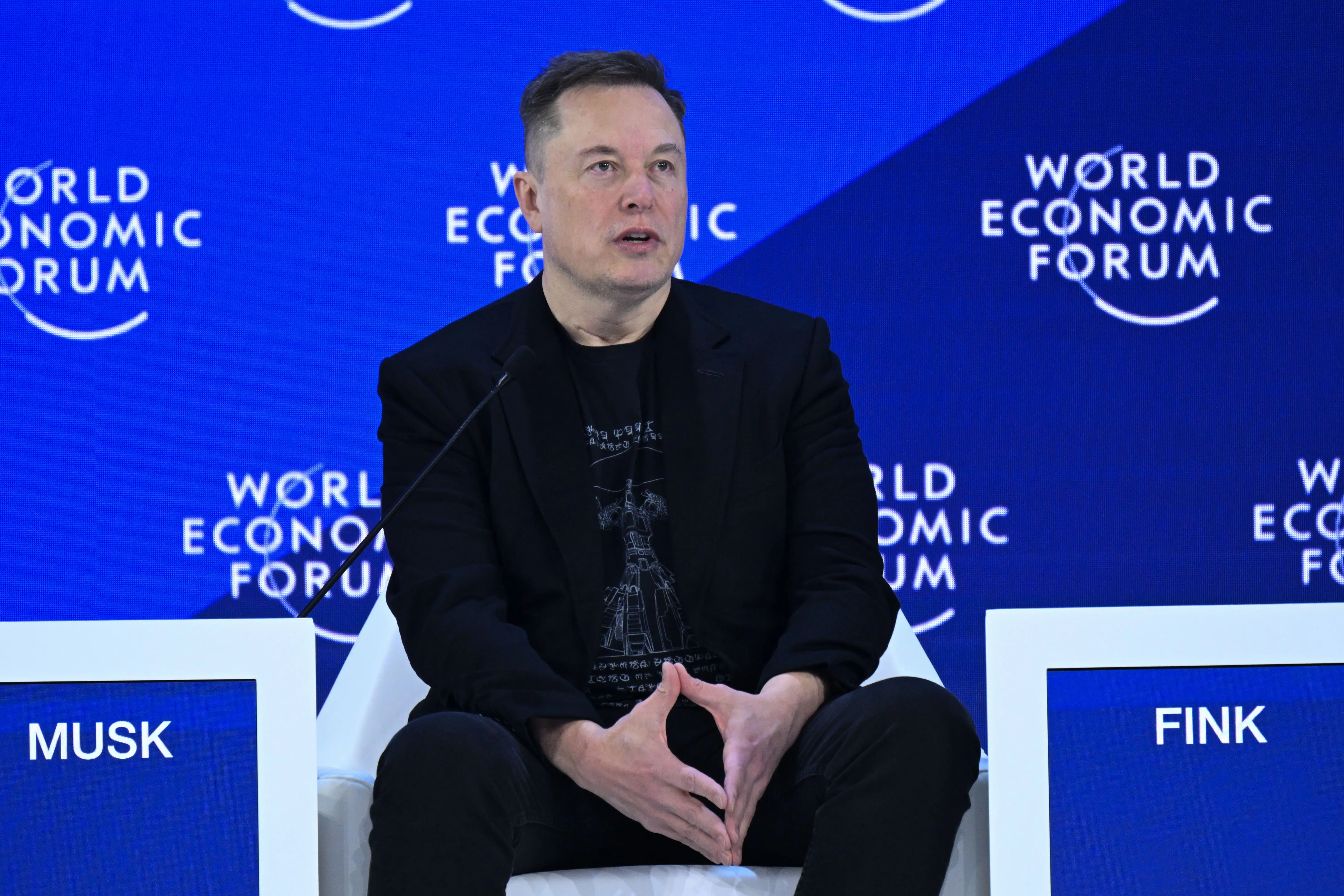 Elon Musk speaks on stage at the World Economic Forum in Davos, Switzerland.