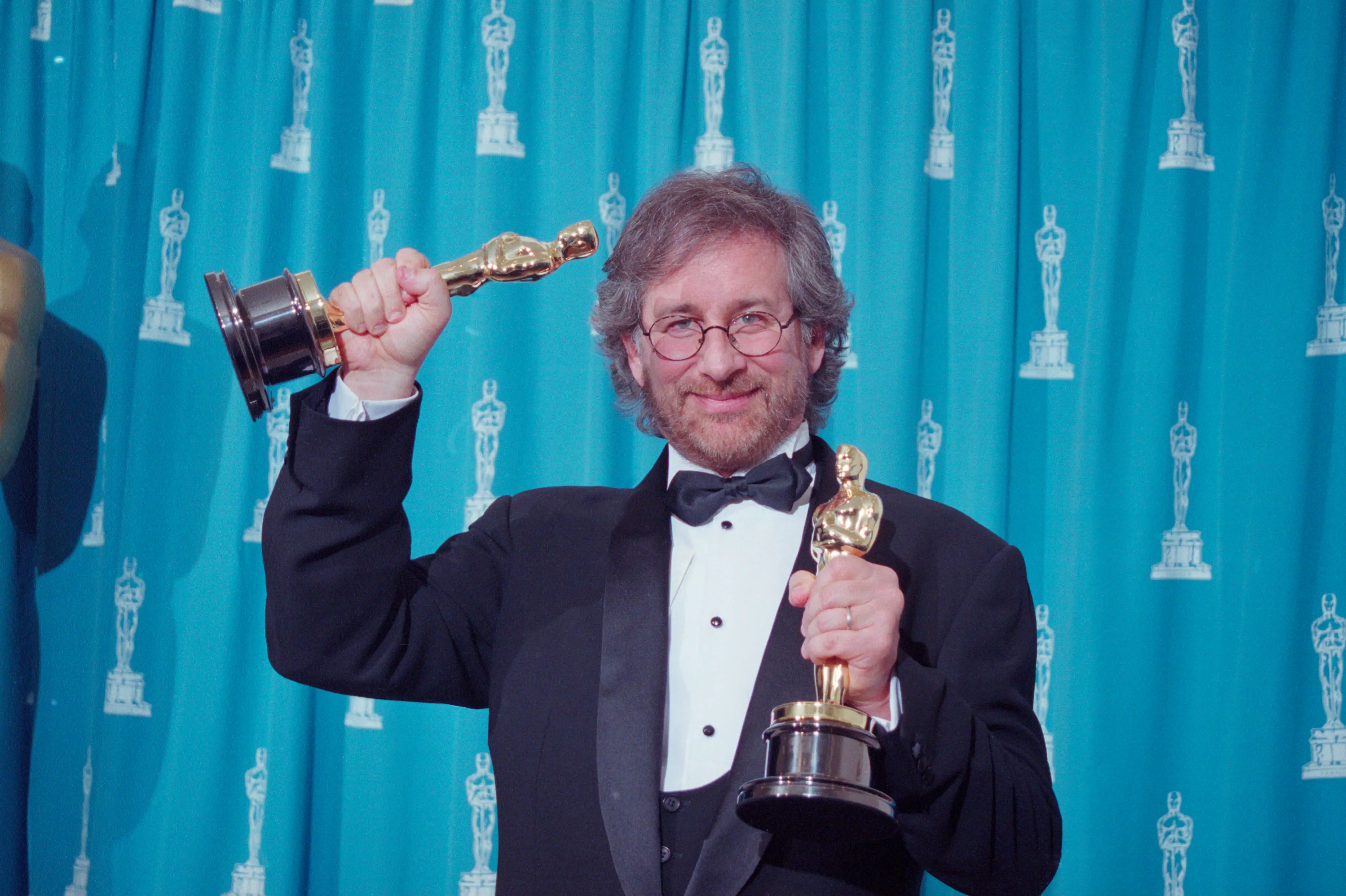 Steven Spielberg holding his two Oscars at the 1994 Academy Awards.